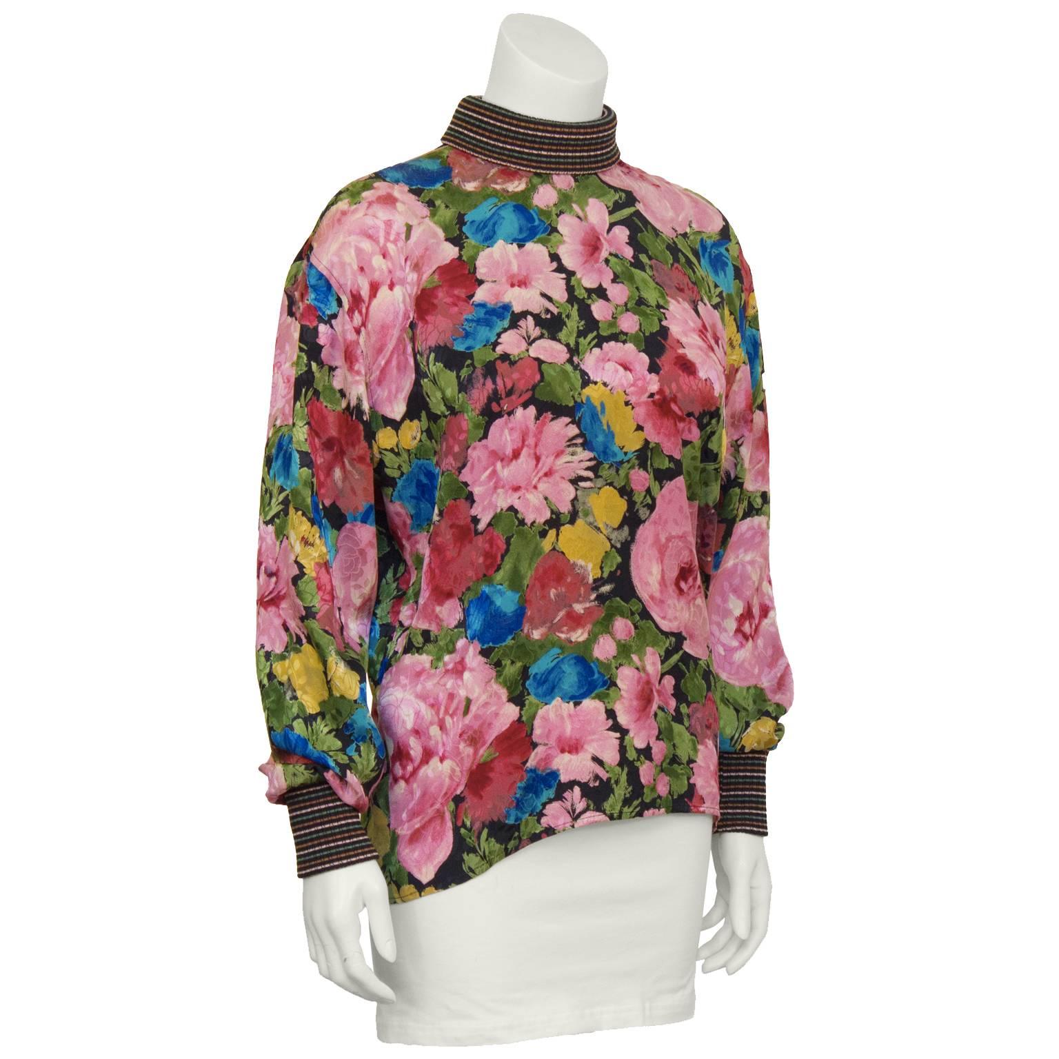Silk floral printed mock turtleneck blouse by Ungaro from the 1980's. The floral silk-jacquard shirt is finished with striped knit ribbed cuffs and collar. Buttons down the back are marbleized silver. Two buttons on the back are slightly chipped,
