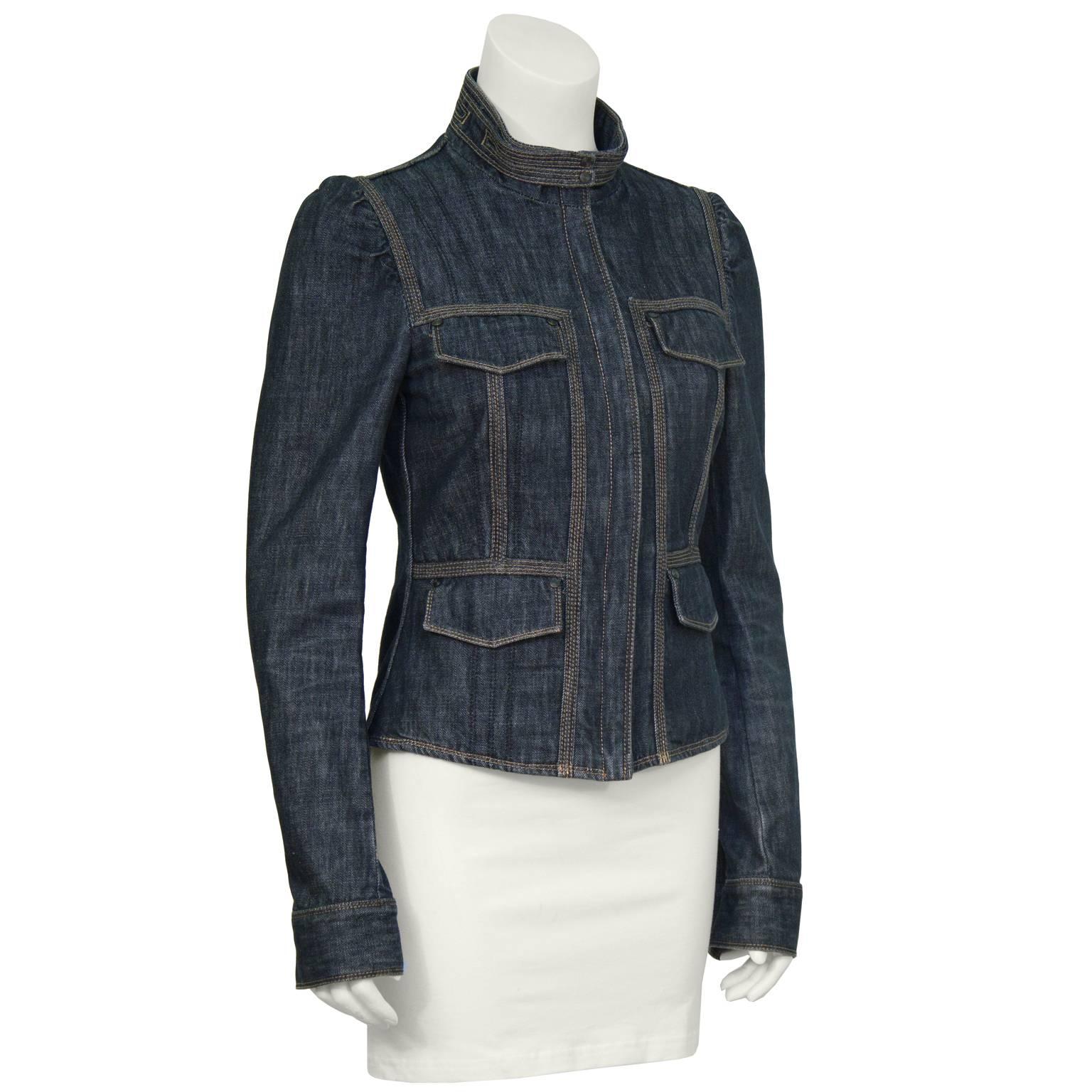 2002 Gucci from Tom Ford era dark denim jacket. The jacket features a high collar with two snap buckles, a zip front and slightly puffed shoulders. The cuffs close with zipper and double snap closure, four top flap pockets on the front. Seams down