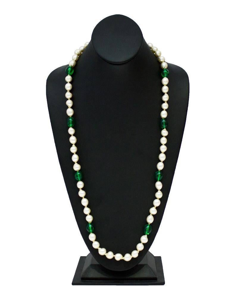 1960's long pearl necklace with eight green poured glass beads from the 1960's. The finish on the faux pearls is in impeccable condition. The necklace is long enough to double up and wear as a two strand piece. Rhinestone embellished fish-hook