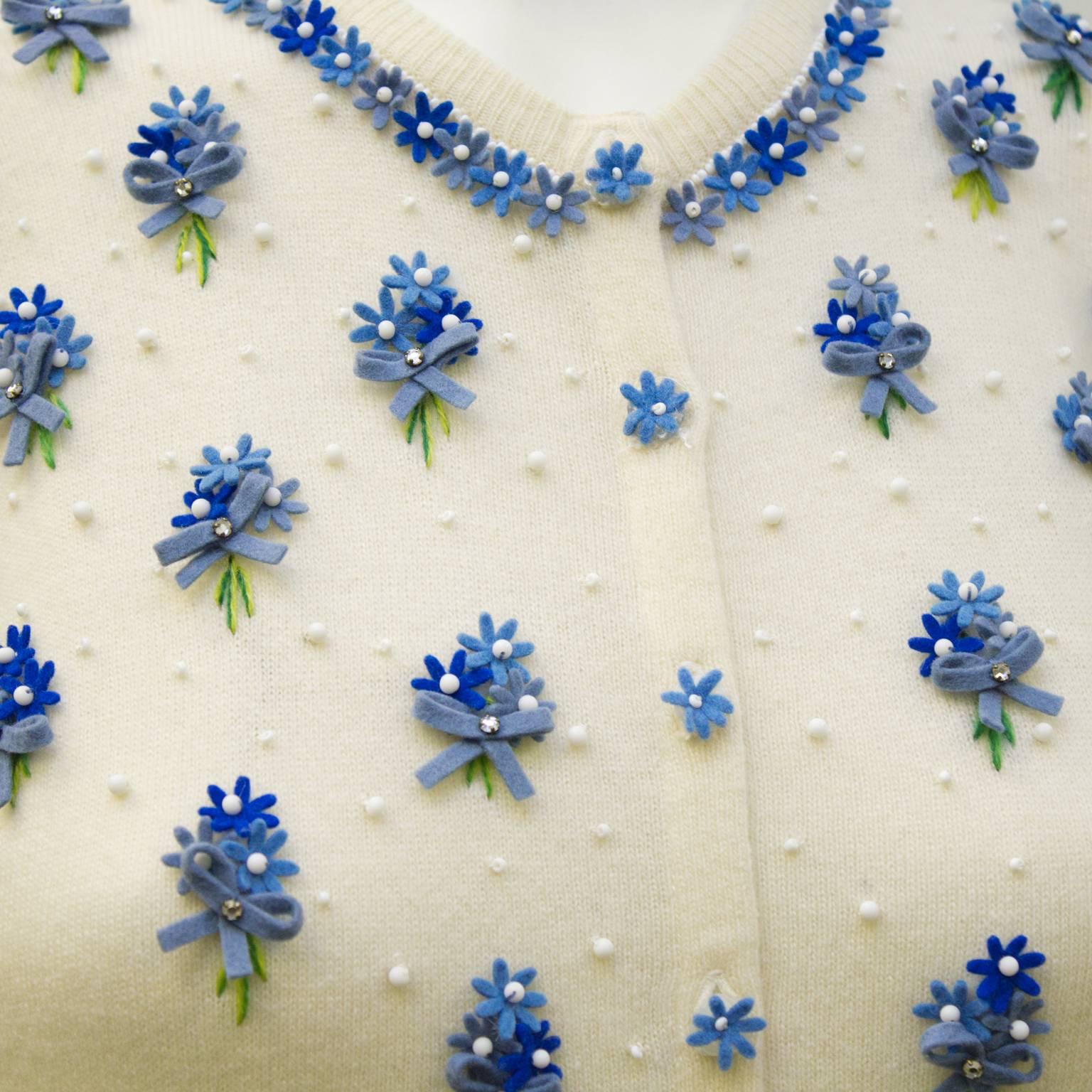 white cardigan with blue flowers