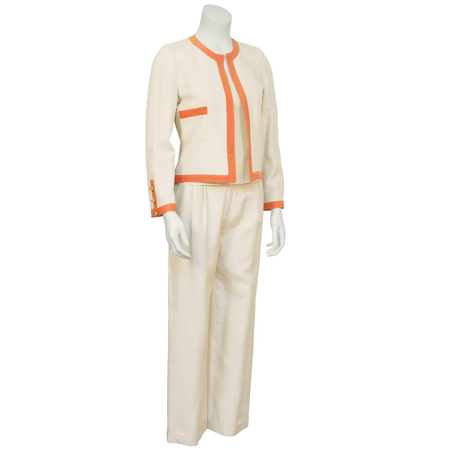 Chanel 1970's cream and orange raw silk 3-piece pantsuit from the collection of Lynn Manulis daughter of the legendary Martha's of Palm Beach. The jacket is in the classic Chanel style with two front pockets, trimmed in orange and features gold