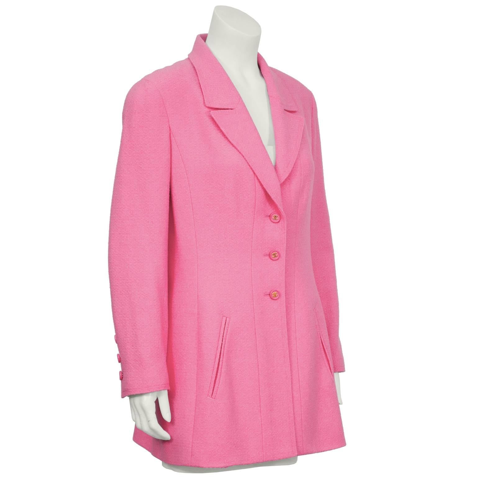 Chanel 1997 pink long line jacket with a notch lapel and diagonal slit pockets on the front. Jacket fastens up the front with pink and gold CC buttons and falls to the mid hip. Matching buttons at the cuffs, signature gold chain sewn into interior
