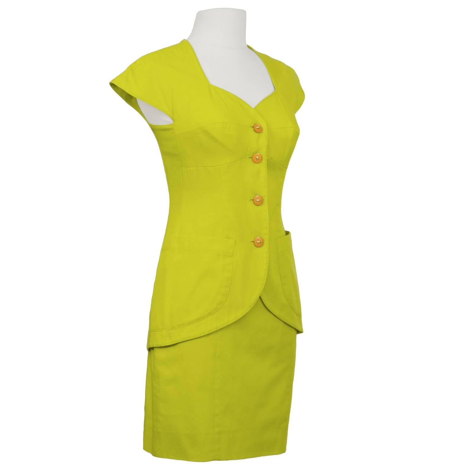 Well known 1980's Italian label Byblos chartreuse cotton jacket and skirt set. Dramatic sweet heart neckline with capped sleeves, long line jacket with descending curve to the hem and 2 patch pockets. Interesting body con stitching on jacket