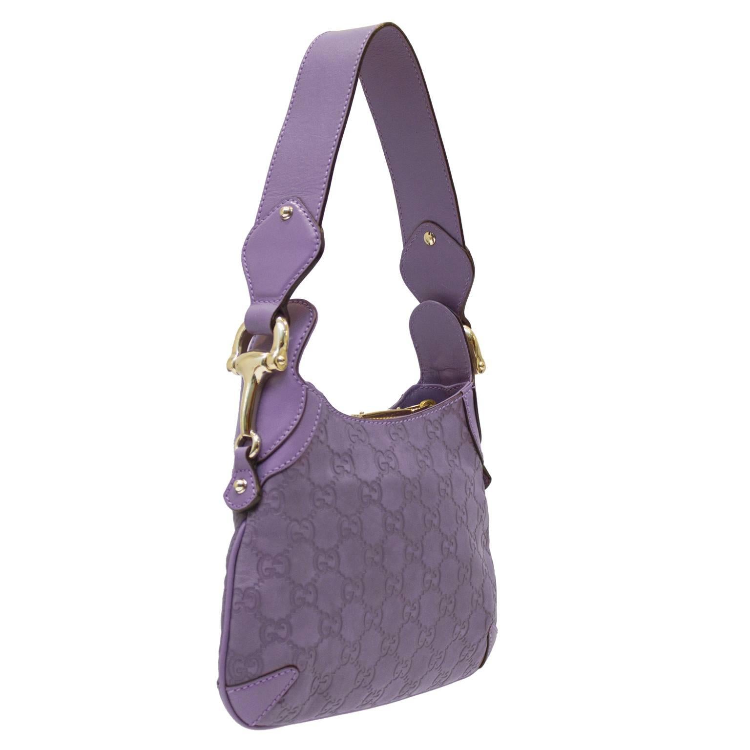 Petit lilac leather hobo handbag from the early 2000's. The wide top handle strap can be worn over the shoulder and the bag is blind stamped with the Gucci monogram pattern. Detailed with silvertone horsebit hardware. The interior is lined in a