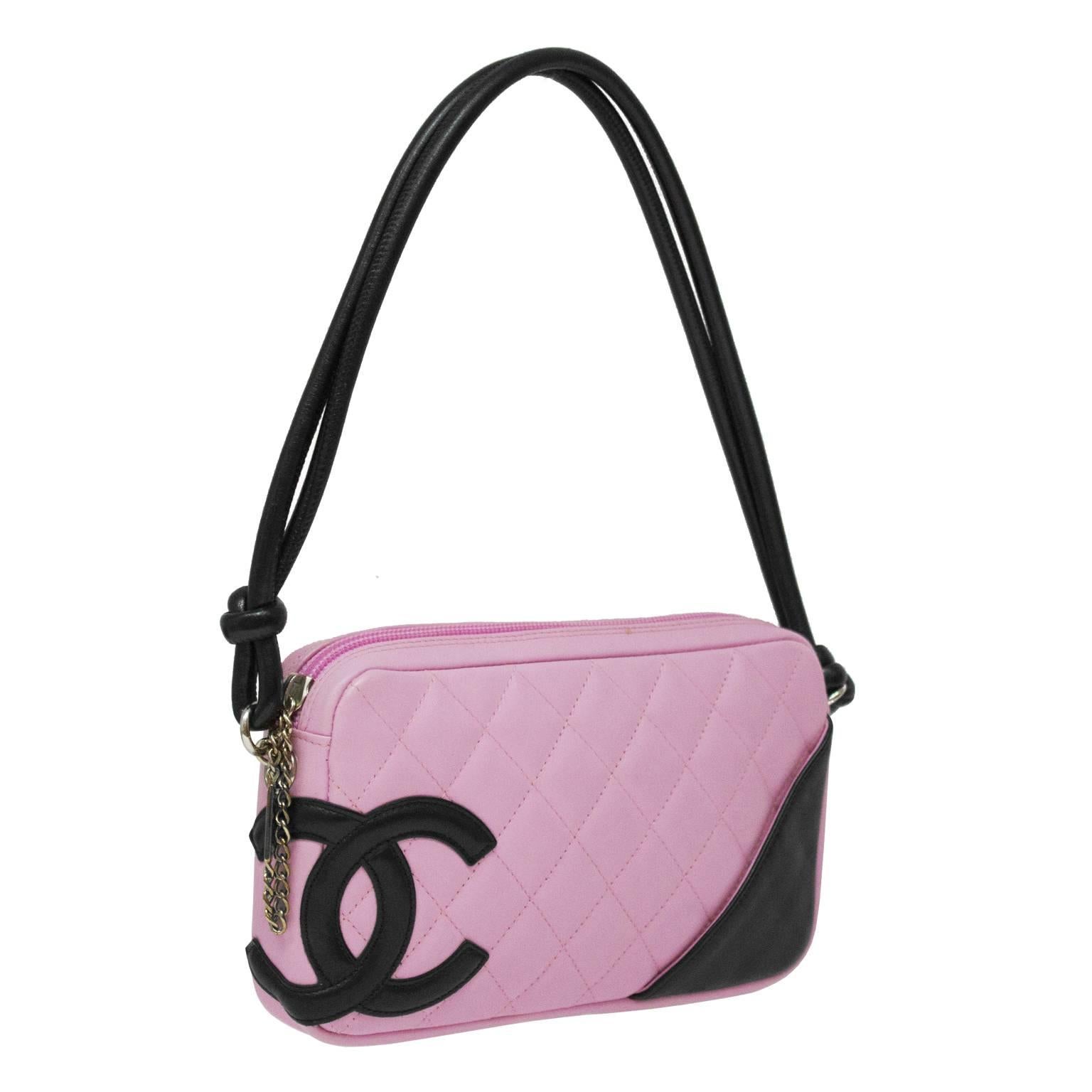 Small rectangular shoulder bag from 2004 Ligne Cambon collection. The bag is a soft pink lambskin leather that is quilted and detailed with a black leather CC. The strap is made of matching black lambskin, is doubled and knotted at the end. The