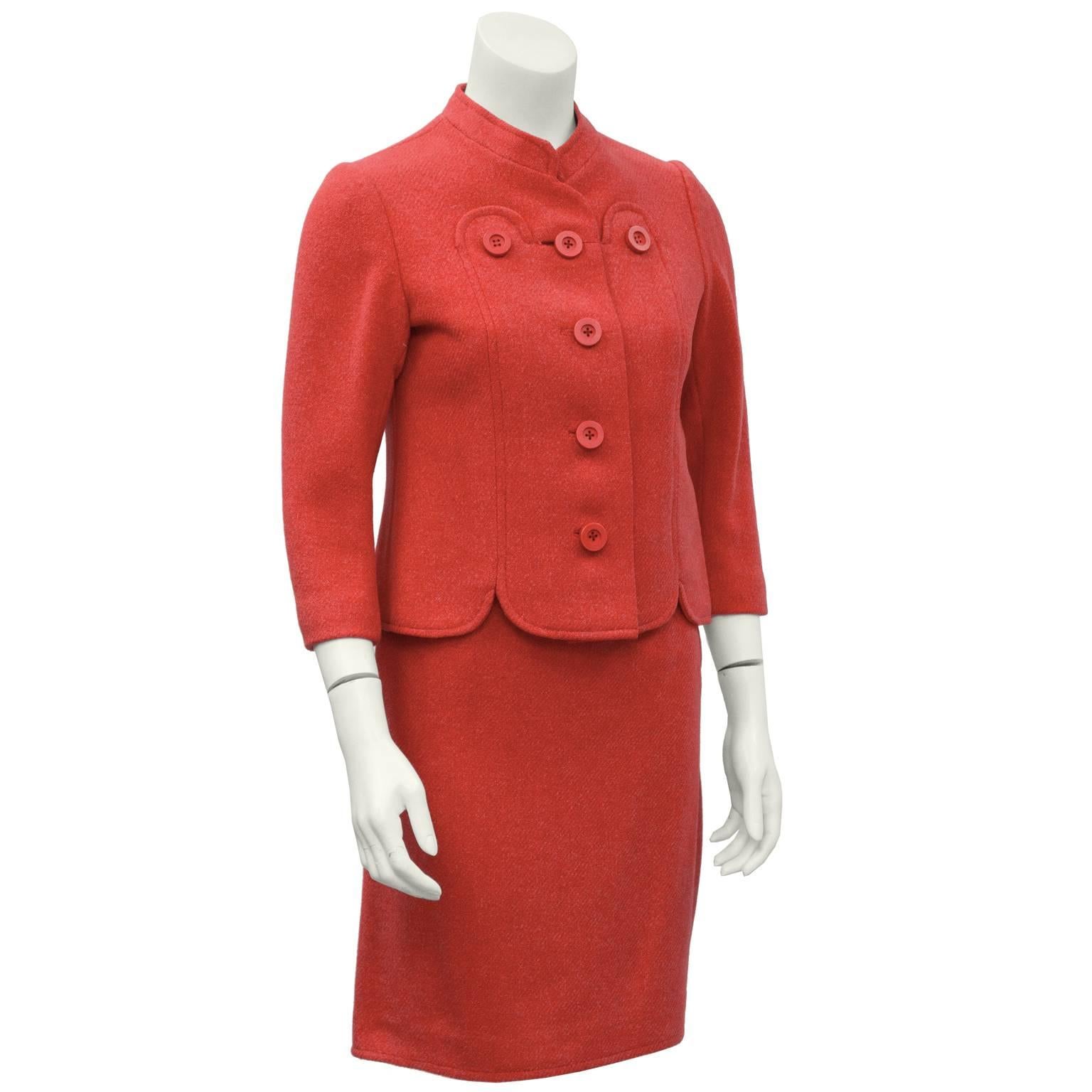 Adorable coral suit by the designer Molyneux from the 1960’s. The fitted jacket has a mandarin style collar and fastens up the front with large matching plastic coral buttons. The scallop edge detail on the front of the jacket, mirrored on the hem,