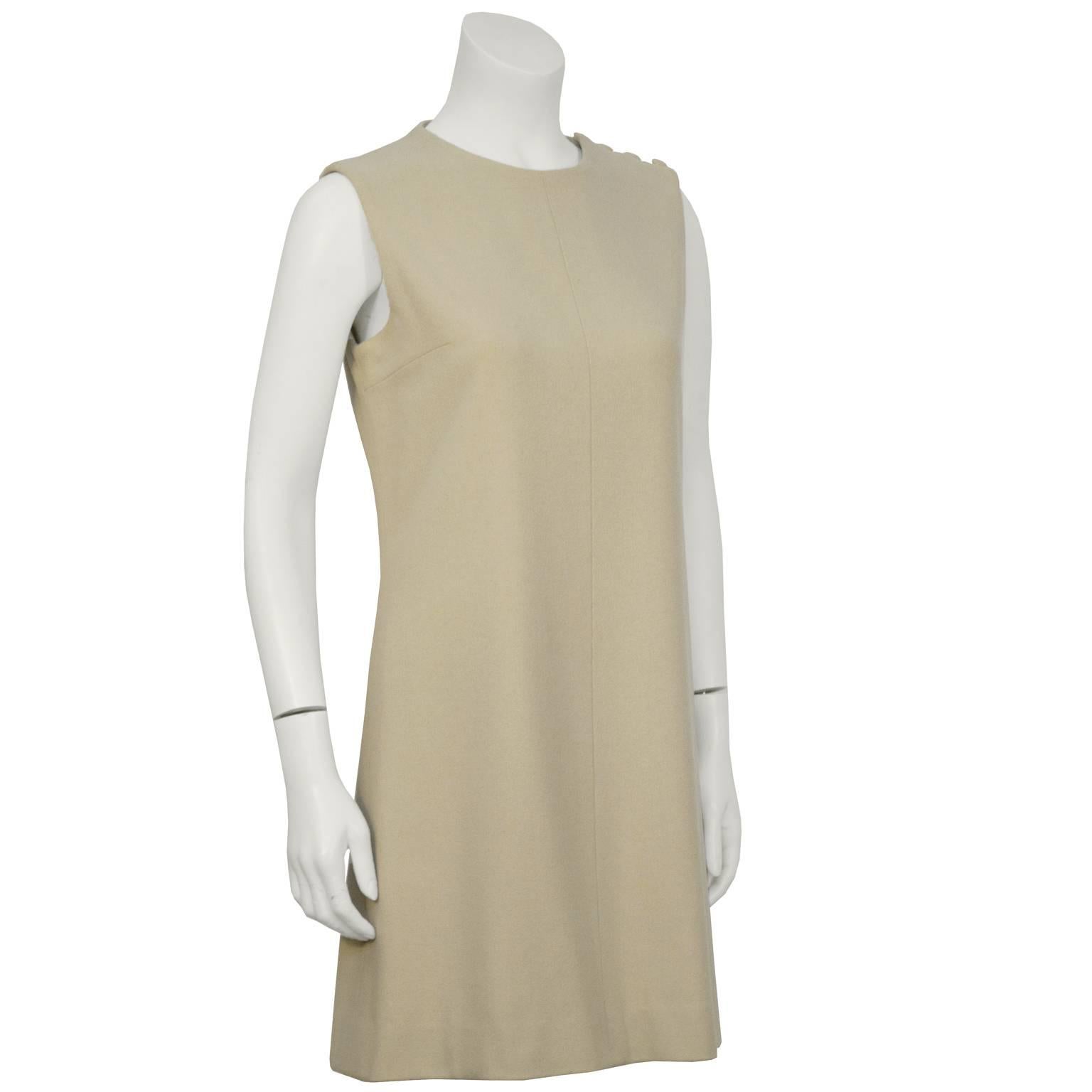 Taupe wool A line Sorelle Fontana dress from the 1960’s. The dress would look great over a long sleeve shirt or as a stand-alone piece. Detailed with a simple seam down the front, darts at the bust and zips up the side with four covered buttons on