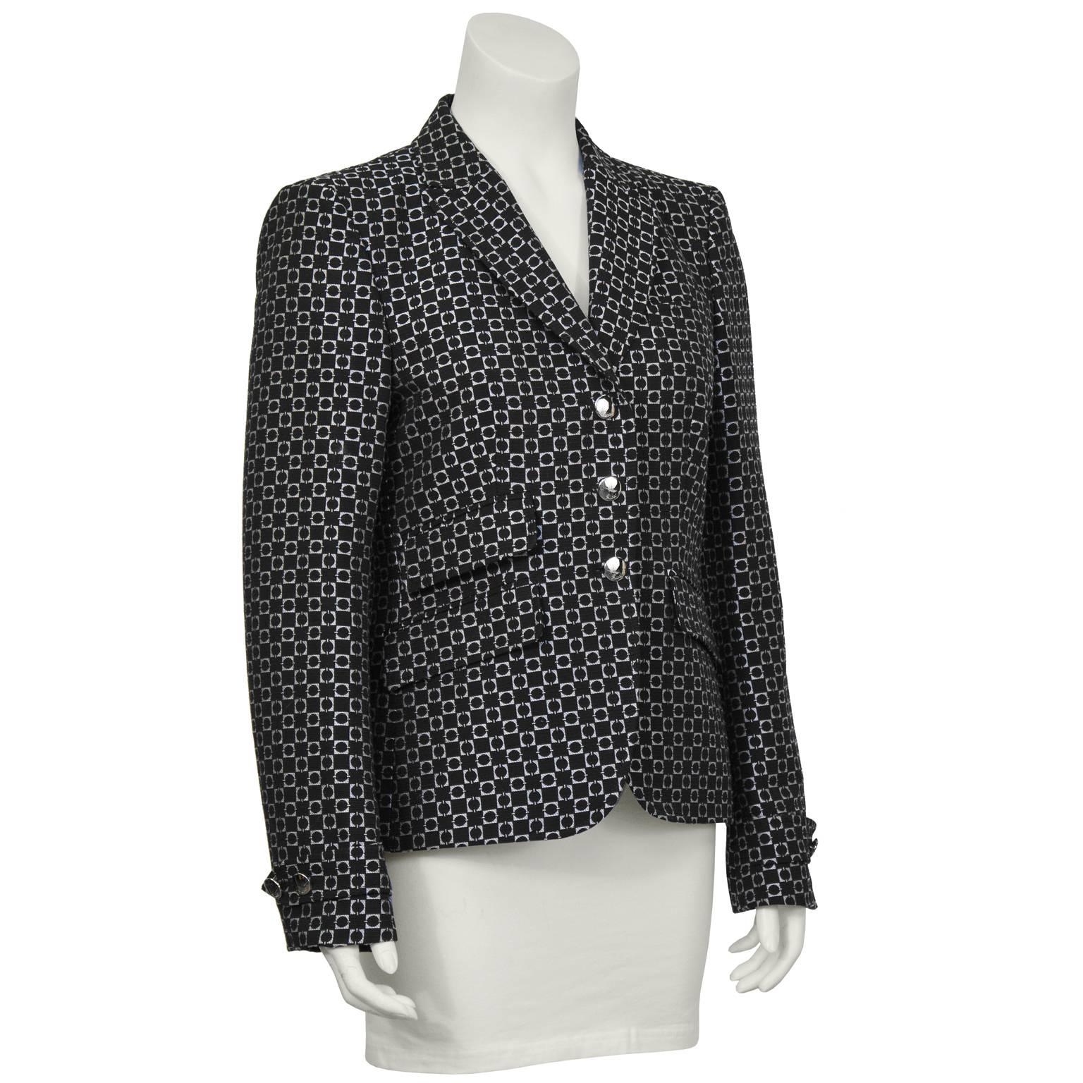 Gucci cotton silk blend blazer from the Fall 2007 runway with an allover geometric black and white print. The fitted jacket features a notched collar, 3 top flap front pockets and silvertone buttons with a cursive Gucci logo on them. Added detail on
