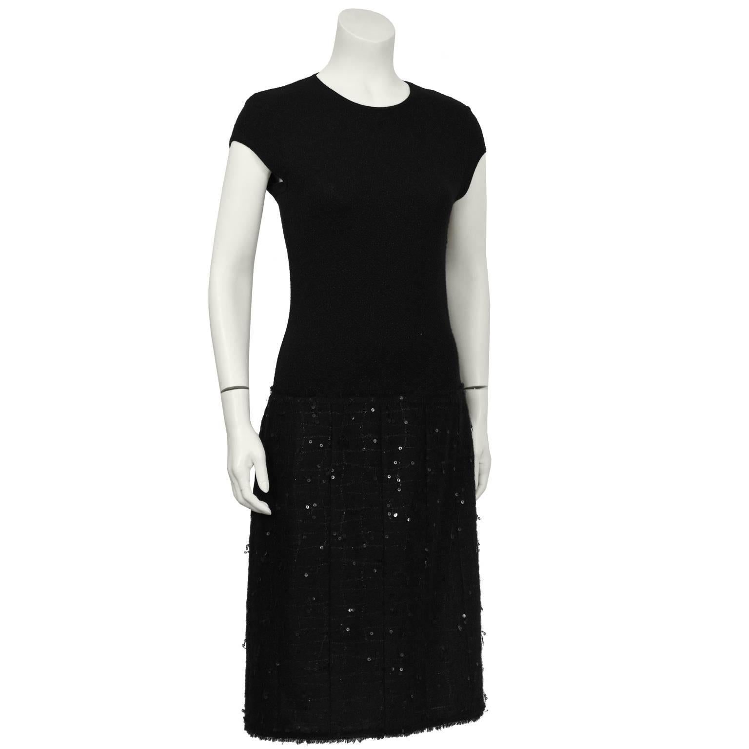 Fall 2004 Chanel black nylon/cashmere/silk blend dress and shawl. The dress features a cap sleeve and a drop waist giving the illusion of a separate skirt. The skirt is adorned with black sequins and gunmetal threading. Hidden zipper at the side and