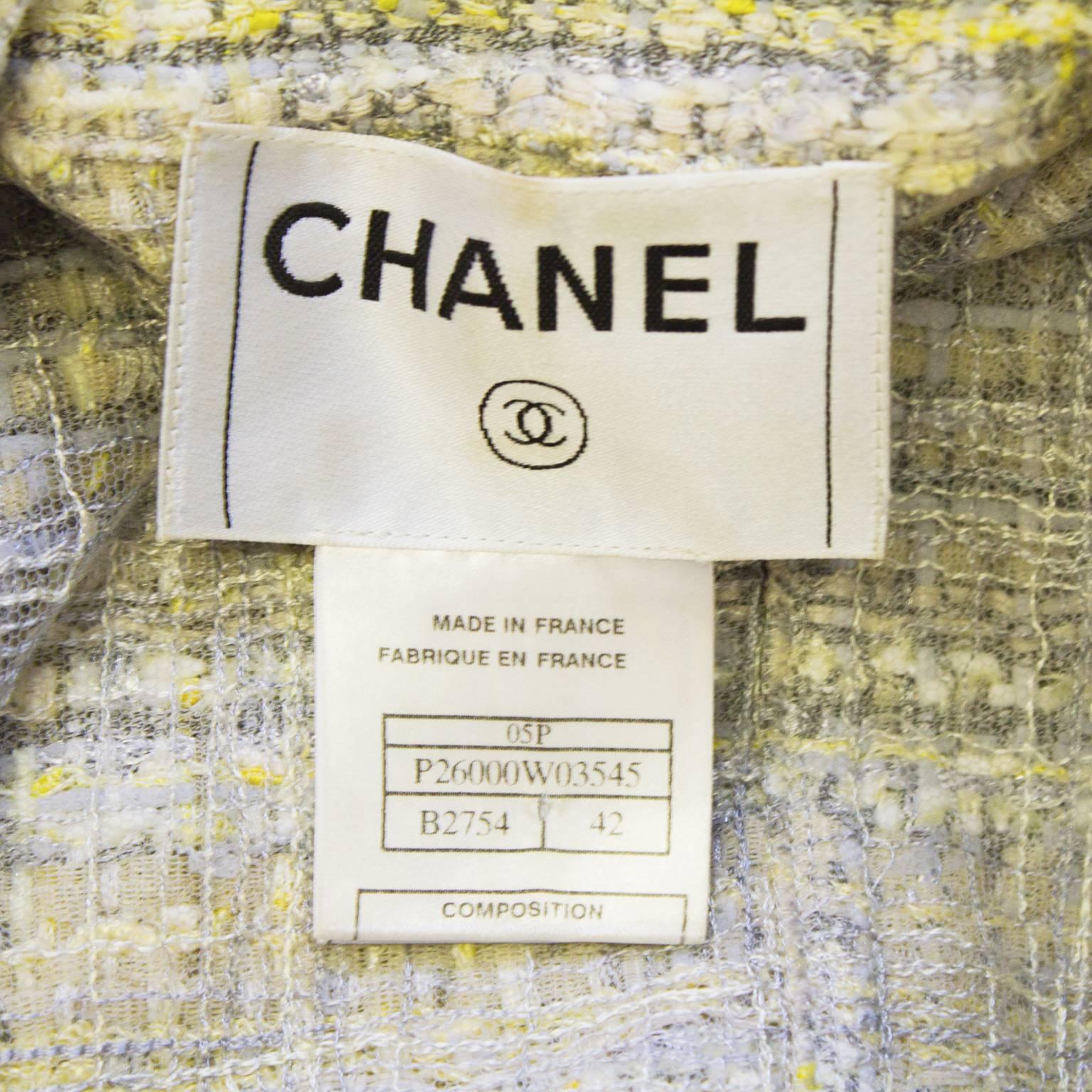 Chanel Spring 2005 lavender and yellow woven tweed. The jacket has a notched lapel, two diagonal slash pockets, and a seam across the bust giving the jacket a fitted shape. The edges of the jacket are left raw by design. Gold and silver tone CC