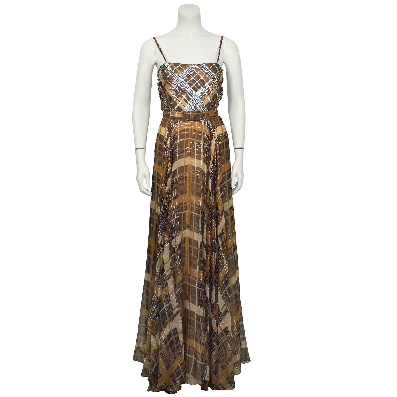 Larry Aldrich brown and silver plaid gown from the 1970's. The spaghetti-strap camisole neckline gown features a silver sequined plaid pattern bodice. Beautiful brown and silver lurex plaid chiffon falls from the natural waist and is gathered on