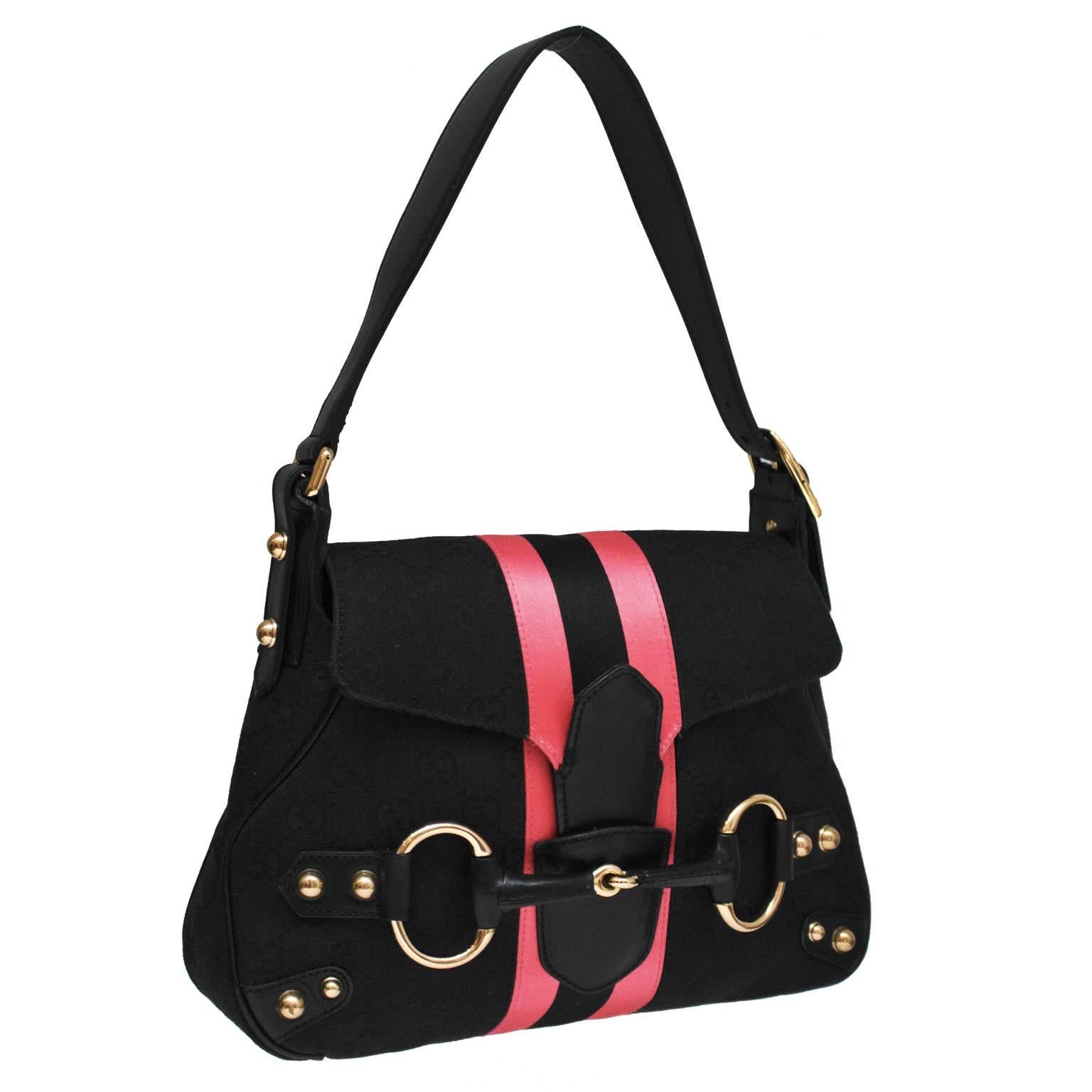 Gucci black canvas monogram mini saddle bag from the Tom Ford era. The bag features a pink and black satin strip down the center with rose gold hardware throughout. Top flap back closes with a leather tab insert and the front is adorned with a large