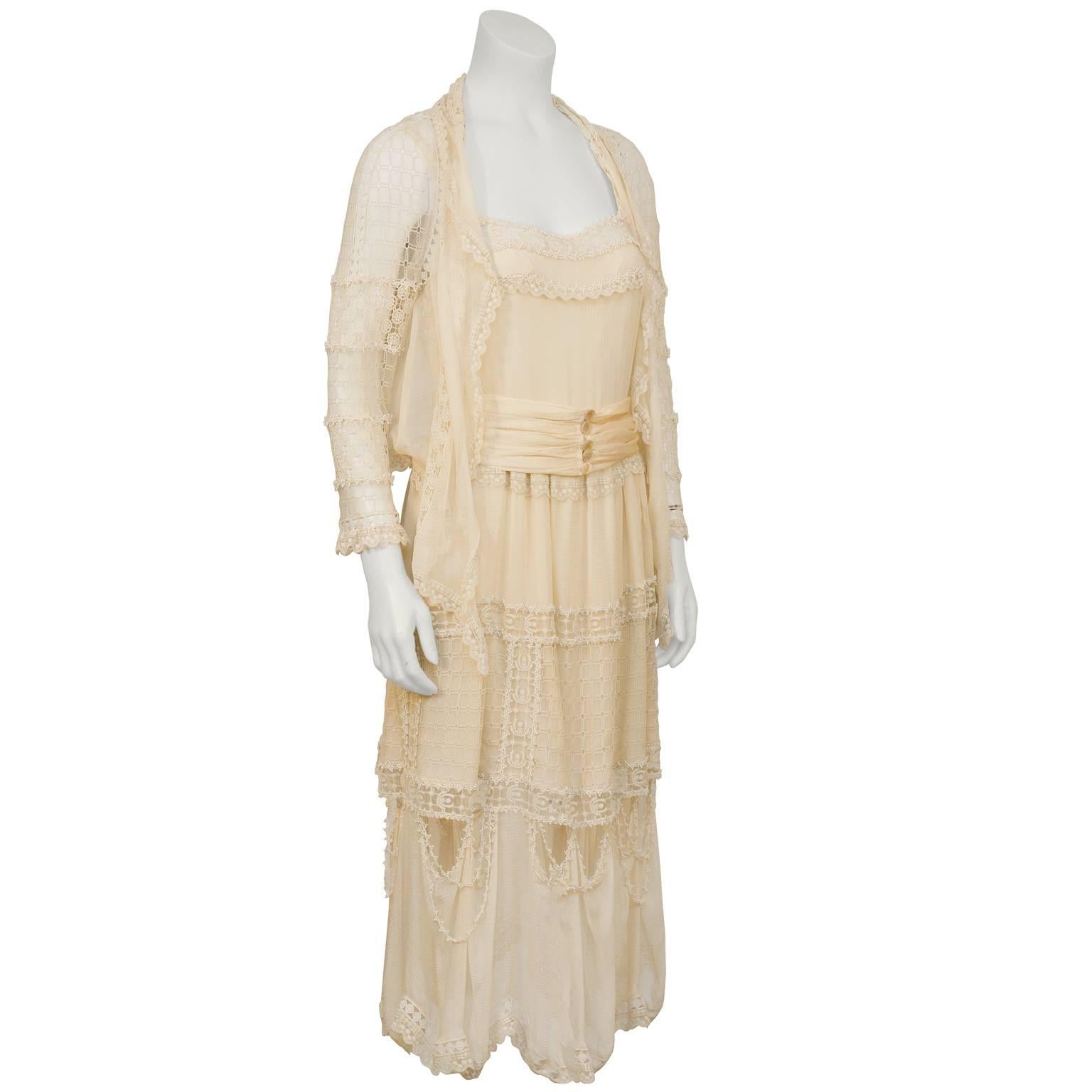 Ultra feminine blush lace dress and jacket by Chloe from the 1970's. The dress is detailed with a variety of laces  and crochet trims along the straps, bust, waist and skirt. The delicate jacket has lace/crochet sleeves, lace panels along the front