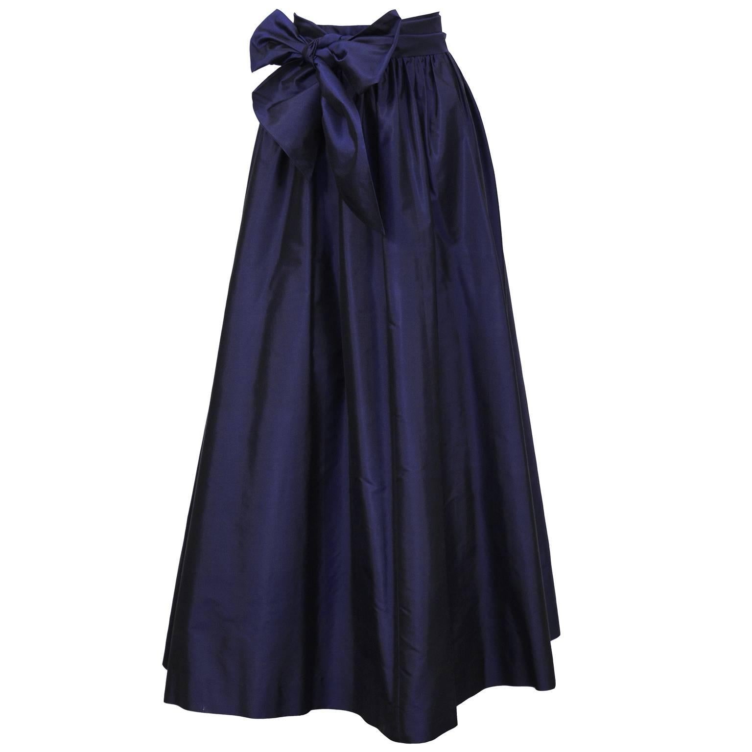 Beautiful Catherine Regehr navy silk taffeta ballgown skirt with matching sash from the 2000's. The skirt has a banded waist with some gathering. Falls to the floor and has a crinoline sewn into the lining. Zips up the back with a flat hook at the
