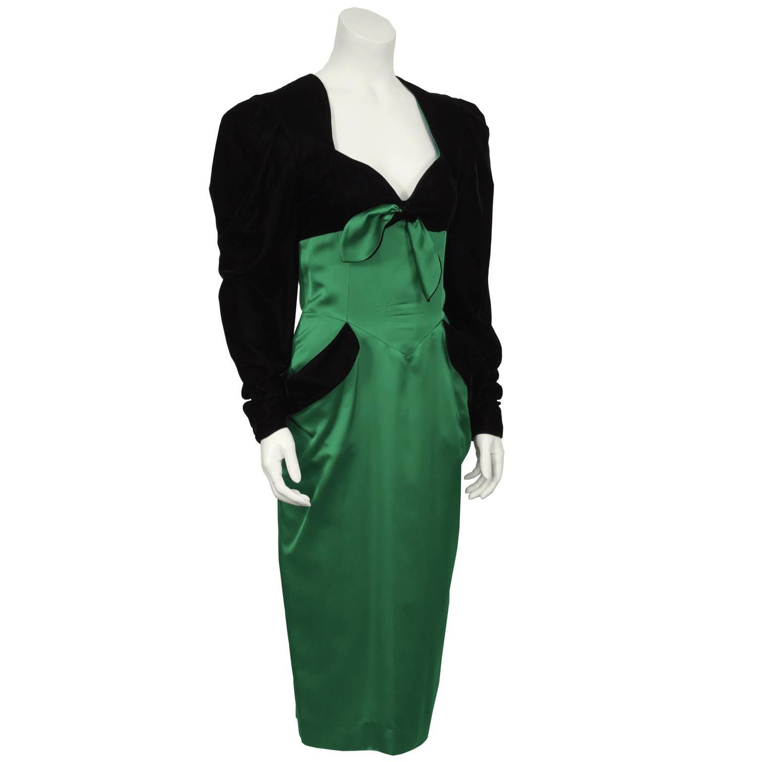 1980's black velvet and emerald satin cocktail dress by the French designer Isabelle Allard. The dress has a sweetheart neckline, fitted bodice and pencil style skirt. The sleeves and bust are made of a black velvet while the rest of the dress is a