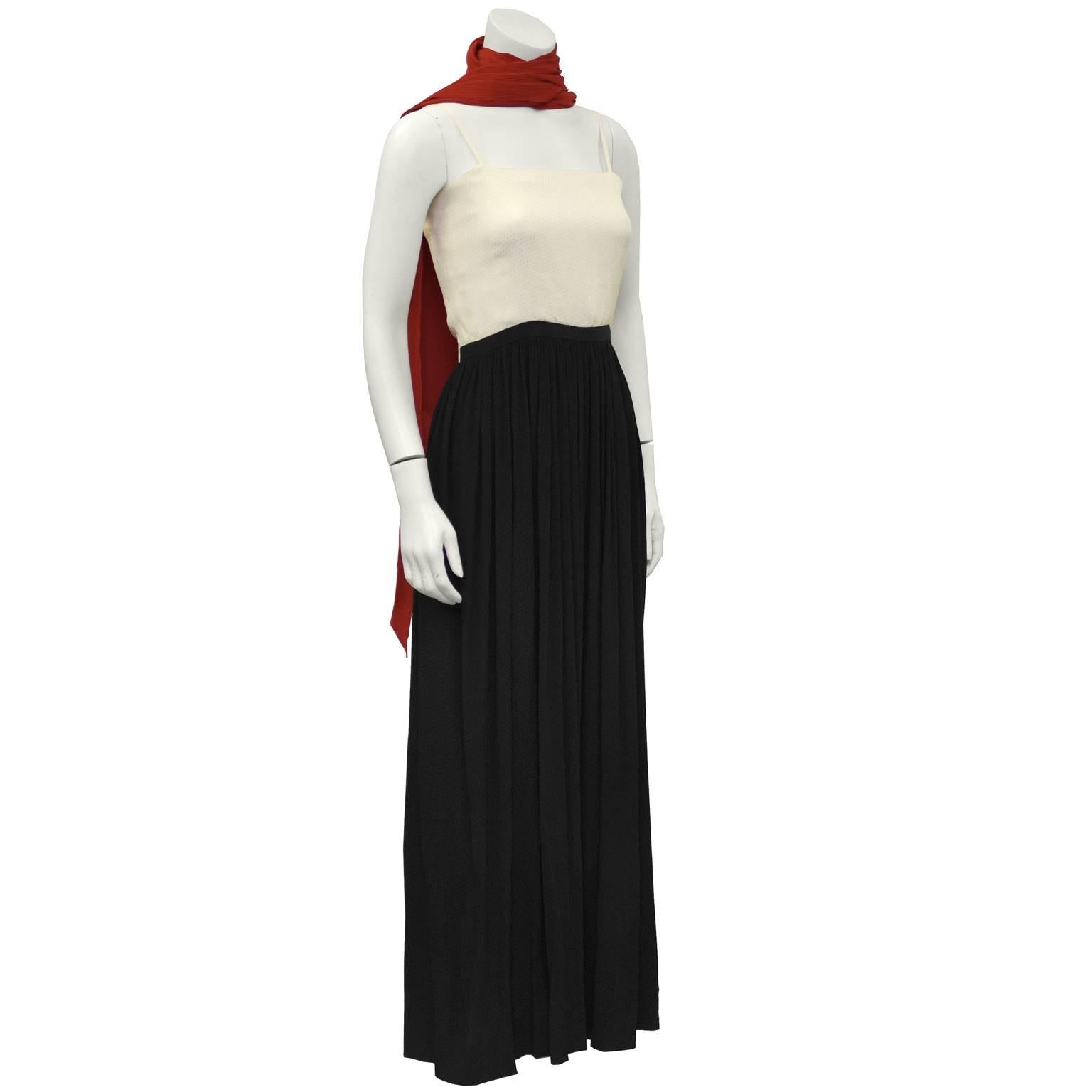 1970's color blocked silk jacquard gown with a matching red scarf. The camisole style neckline is cream and has thin straps. The waist is accented with a black band and a black over layer to the floor. The under layer of the gown is cream jacquard.
