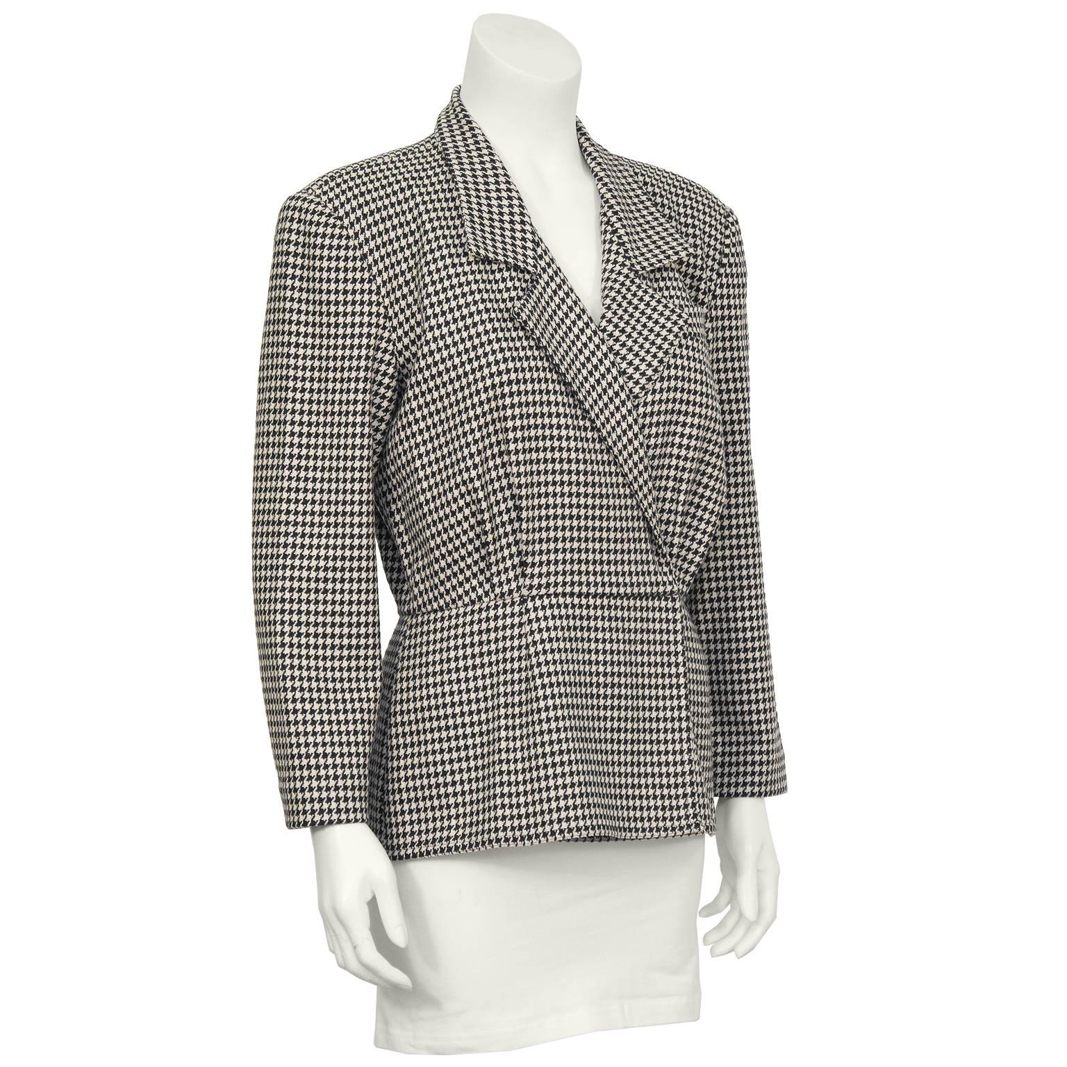 Unique fitted peplum style wool houndstooth check top from the first Michael Kors collection in 1981. The shirt style jacket has a retro 40's shape with an overlapping front that fastens on the inside with hidden flat hooks. Gathering at the bust,