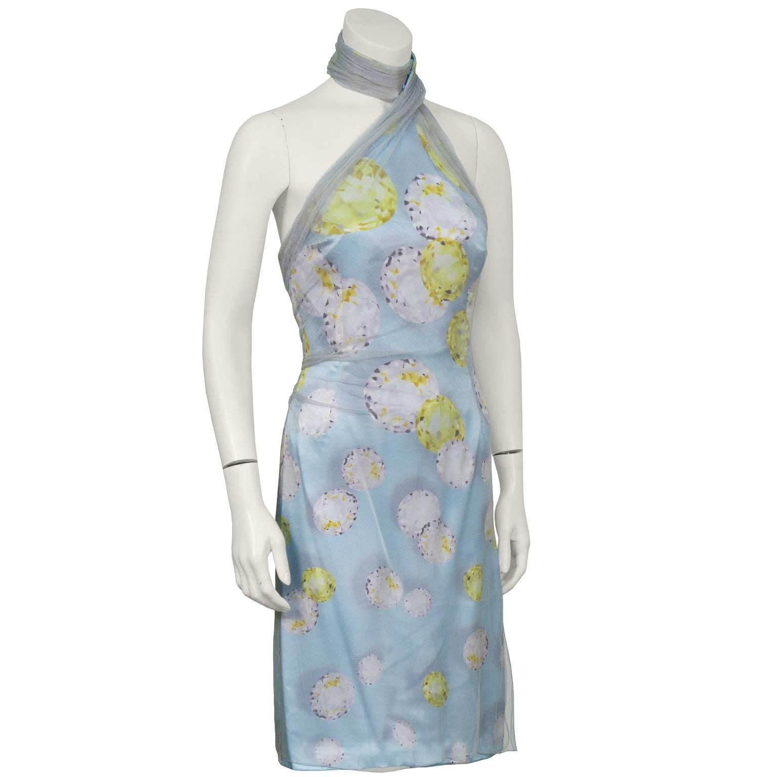 Unusual halter style jewel print dress by Gianni Versace with a dove grey net over layer. The halter fastens at the front of the neck, creating a choker style look, with 4 snap buttons. The net layer is gathers along the bust and across the back.