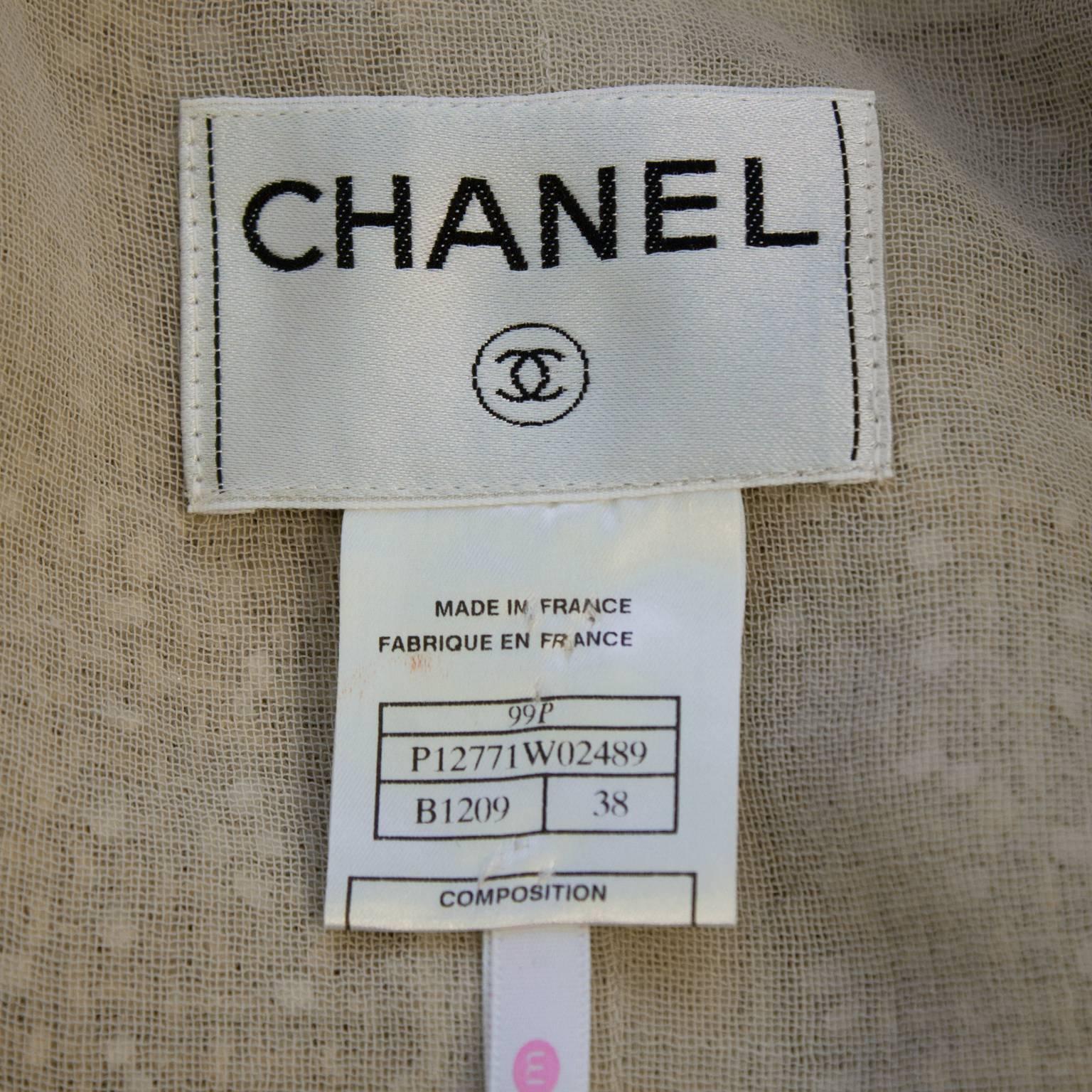 1999 Chanel boucle dinner suit trimmed in blush freshwater pearls along the cuffs, pockets, and edge of jacket. Finished with large single pearl buttons at the cuffs. The jacket has a hidden hook and eye closure at the collarbone. Lined in fine