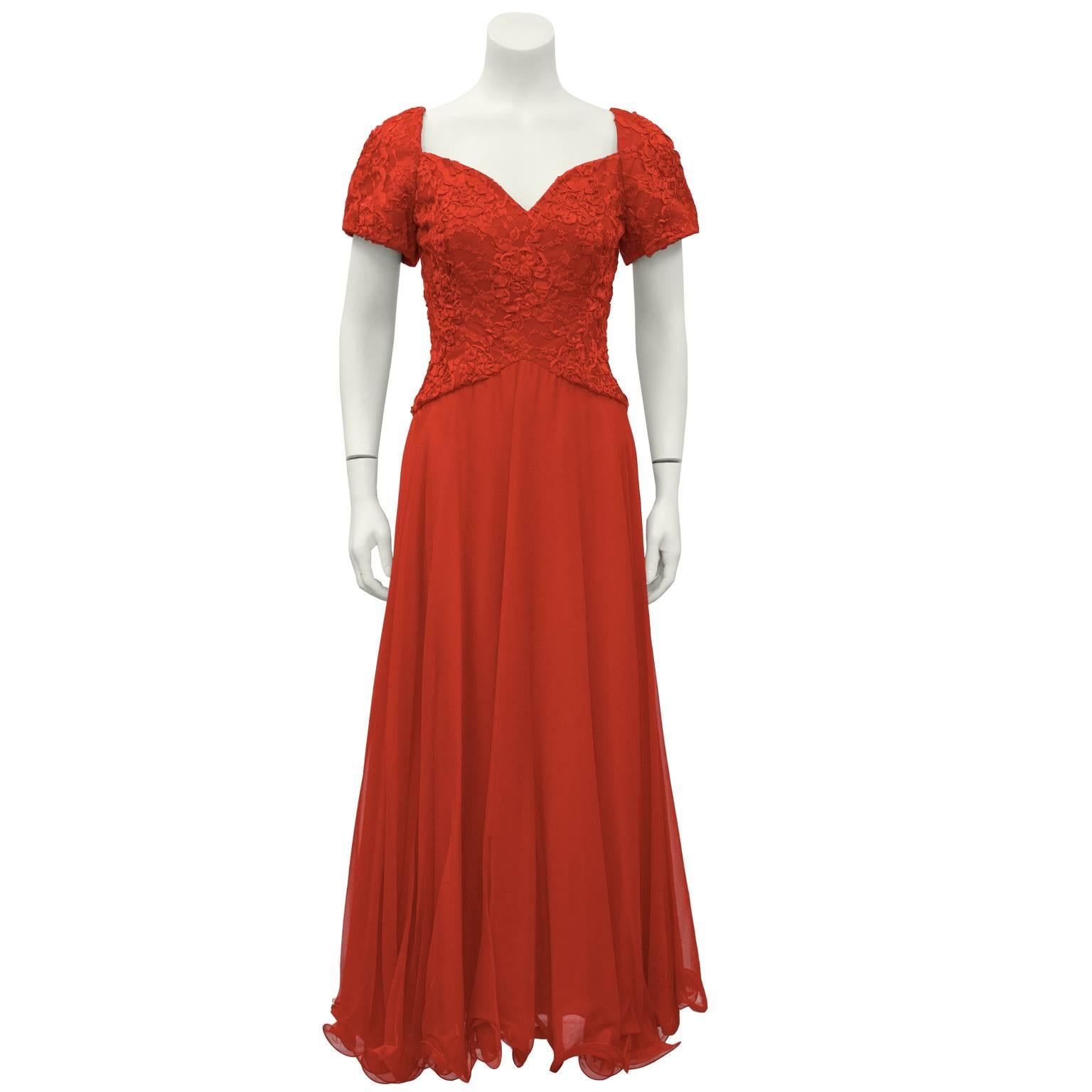 Scaasi, never worn, red lace and satin gown with matching jacket from the 1980's. Dress has sweetheart neckline, lace bodice and short sleeves. The chiffon layered skirt falls from the natural waist and is finished with a ruffled horsehair under