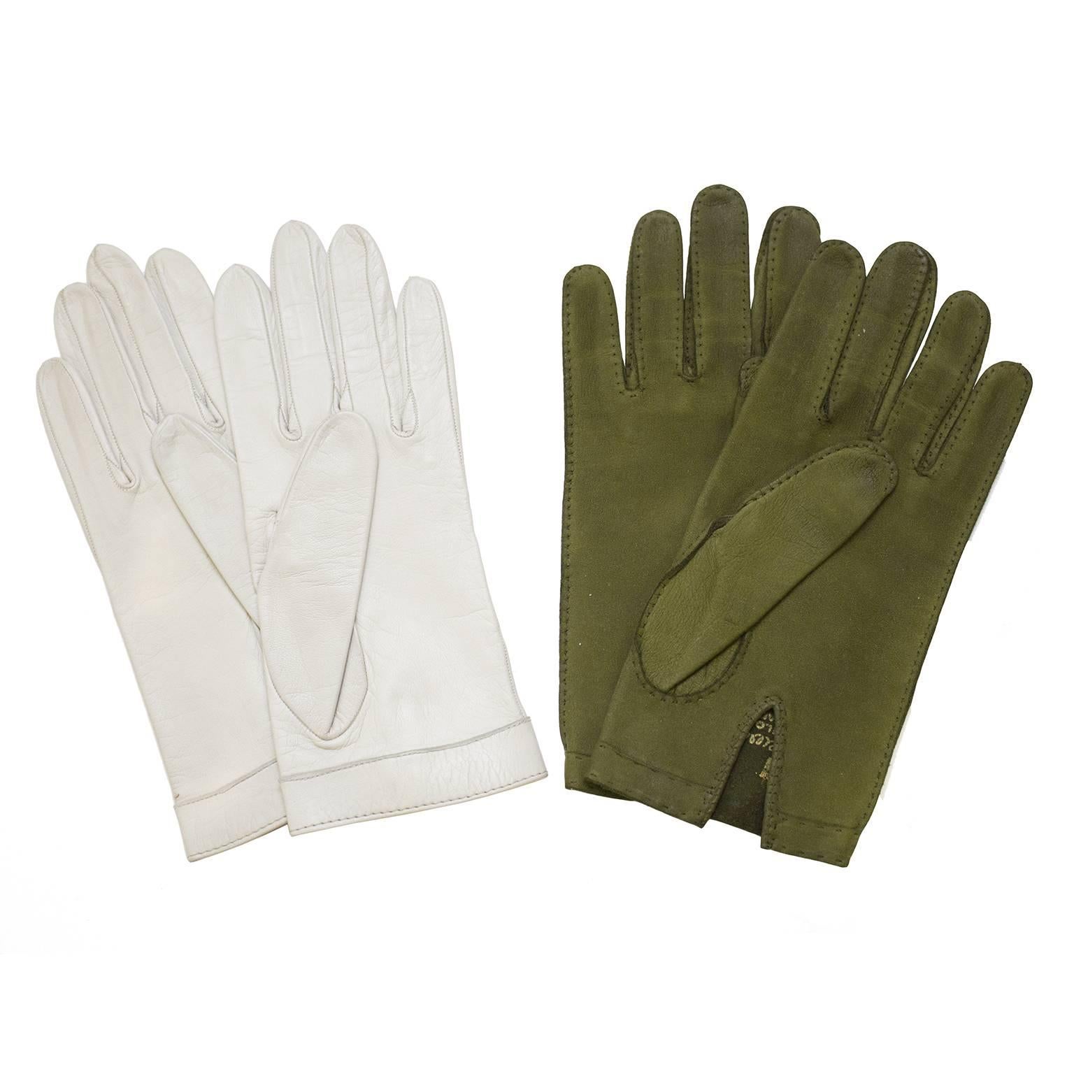 Two pairs of Italian kid leather gloves from the 1960's with gold buckles. The first pair are white leather with a keyhole at the wrist and a gold clamp style buckle that can be opened. The second pair are olive green suede with a gold double loop