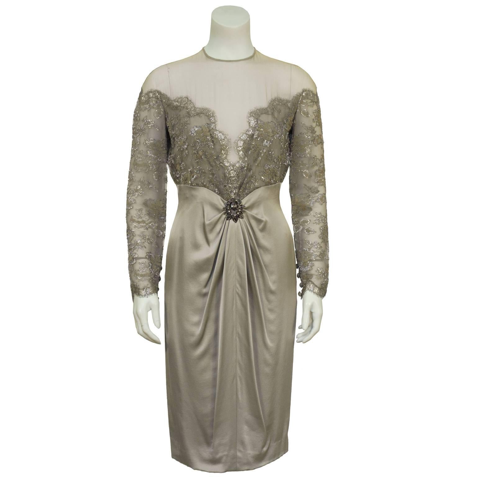 1980's unworn silver lace and taupe satin cocktail dress with illusion neckline by Jean Louis Scherrer. French couturier known for his elegant designs. Upper bodice in silver lace that finishes below the bosom with a subtle V and gathers to a sewn