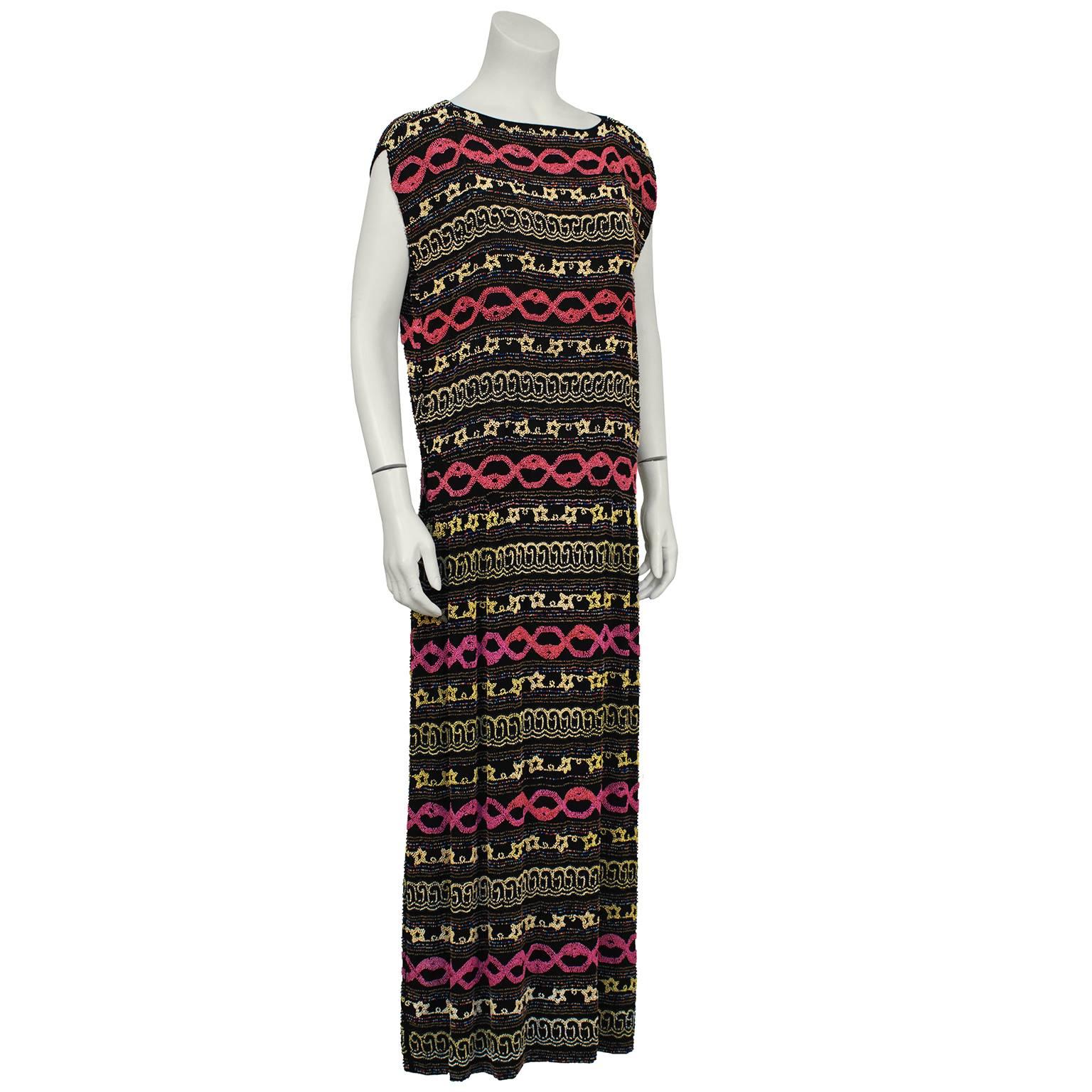 Unusual 1920's Art Deco black silk crepe and pastel beaded flapper style beaded sheath dress with sewn in label from Adair, Paris, 4 Cite Paradis. They specialized in beaded dresses that were exported to the US, UK and Canada. Slight cap sleeve,