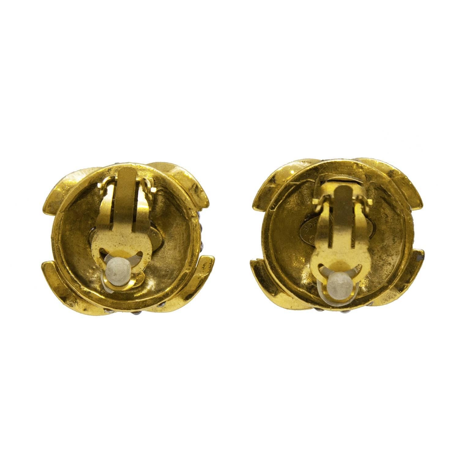 Chanel collection 23 goldtone rhinestone encrusted clip on earrings from the early 1990's. Large round dome covered in small rhinestones with a CC over it. In excellent condition, authenticity plate on the underside. 