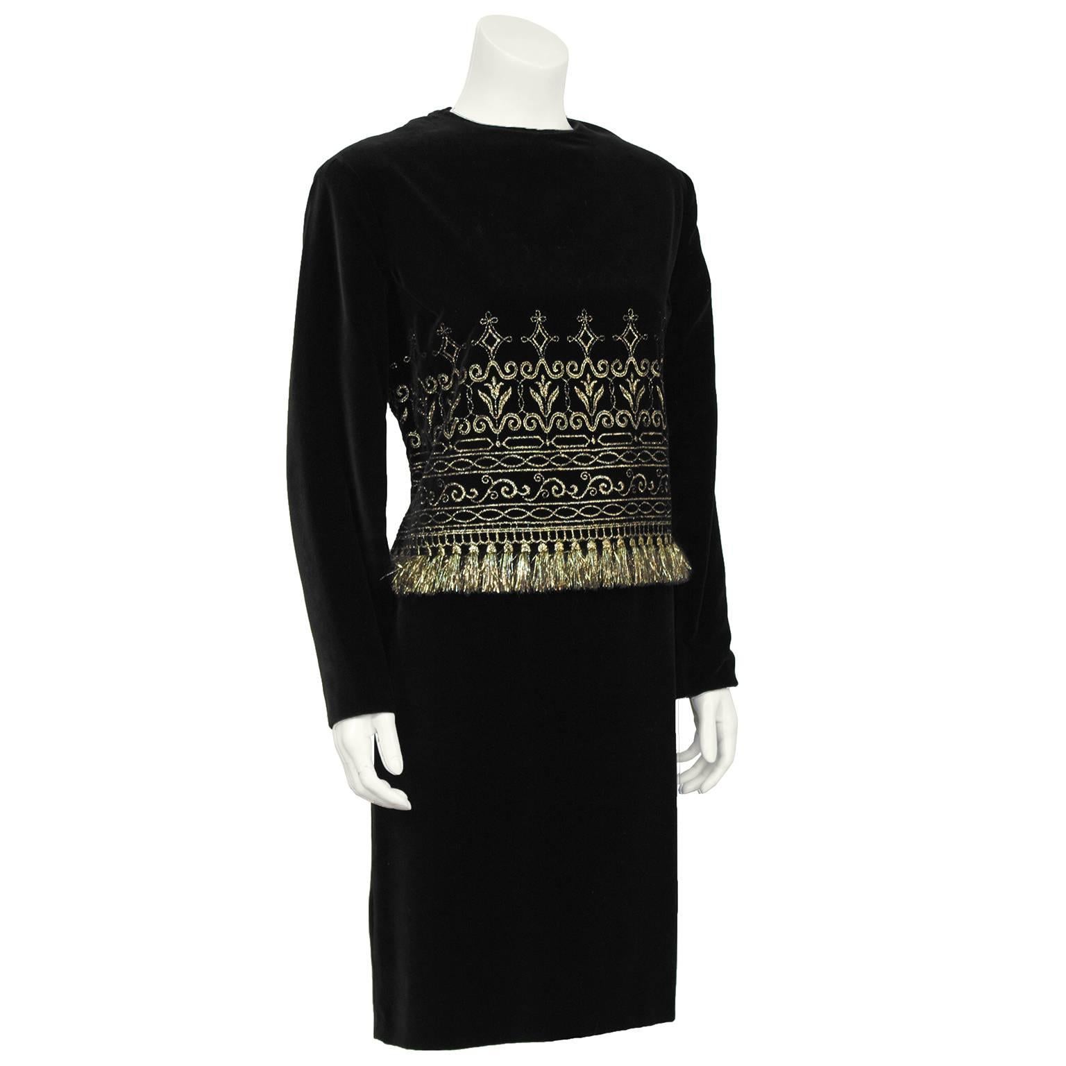 Black velvet Zandra Rhodes cocktail dress from the 1980's. The long sleeve, high neck dress has an intricate gold thread embroidered mid section that finishes with a fringe along the waist. Falls to the mid thigh and zips up the back. In excellent