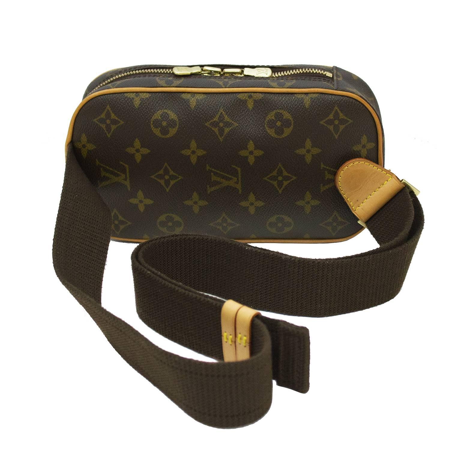 Pristine Louis Vuitton monogram coated canvas pochette gange from the 1990's. The cross body style bag has one open exterior pocket for easy access and a larger zipper interior pocket. The adjustable cross body strap is made of matching brown cotton