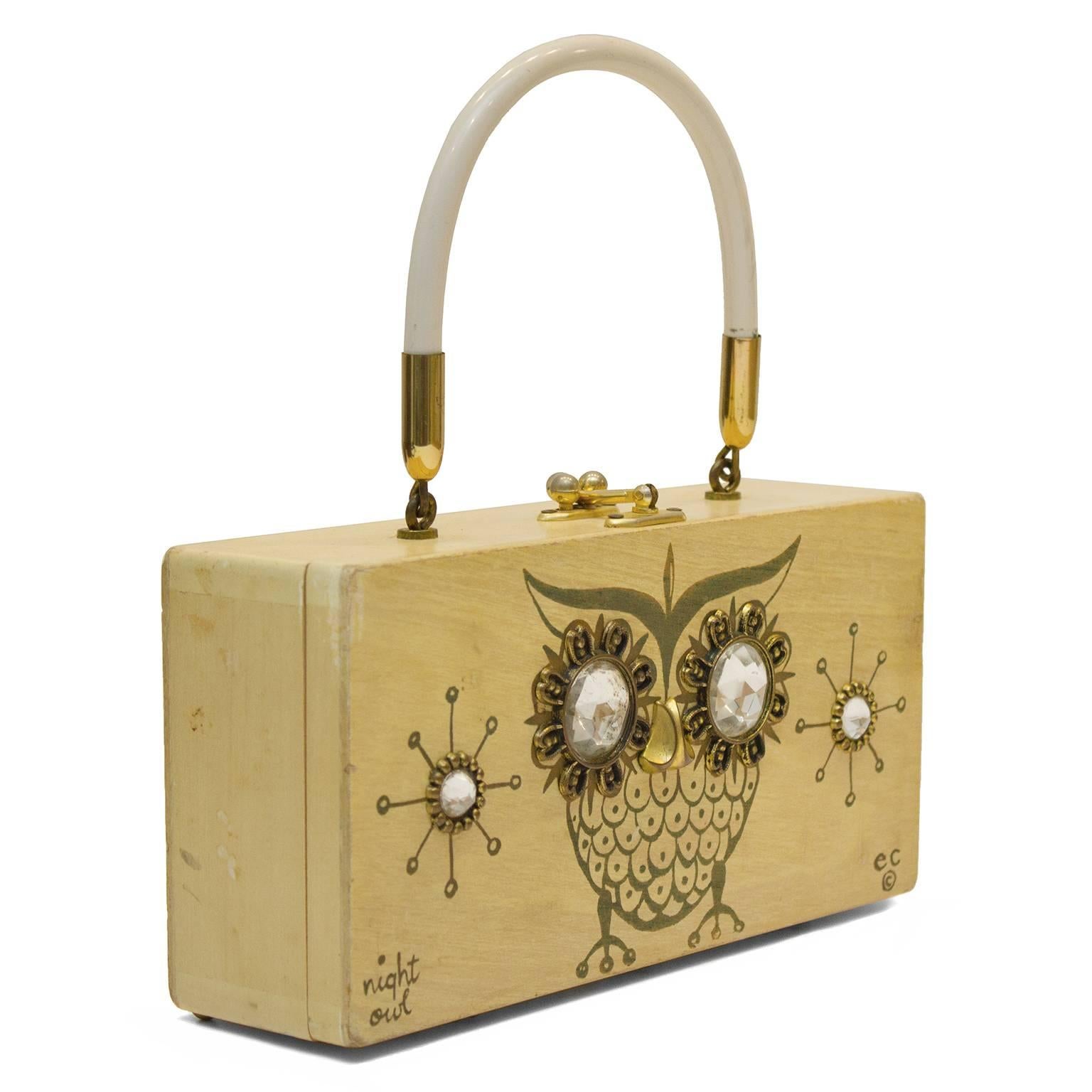 Beautiful 1960's Enid Collins wooden box bag. The body of the bag is made of light wood with an owl motif painted on the front side and adorned with large and medium rhinestones and some brass colored hardware. White rigid top handle is attached