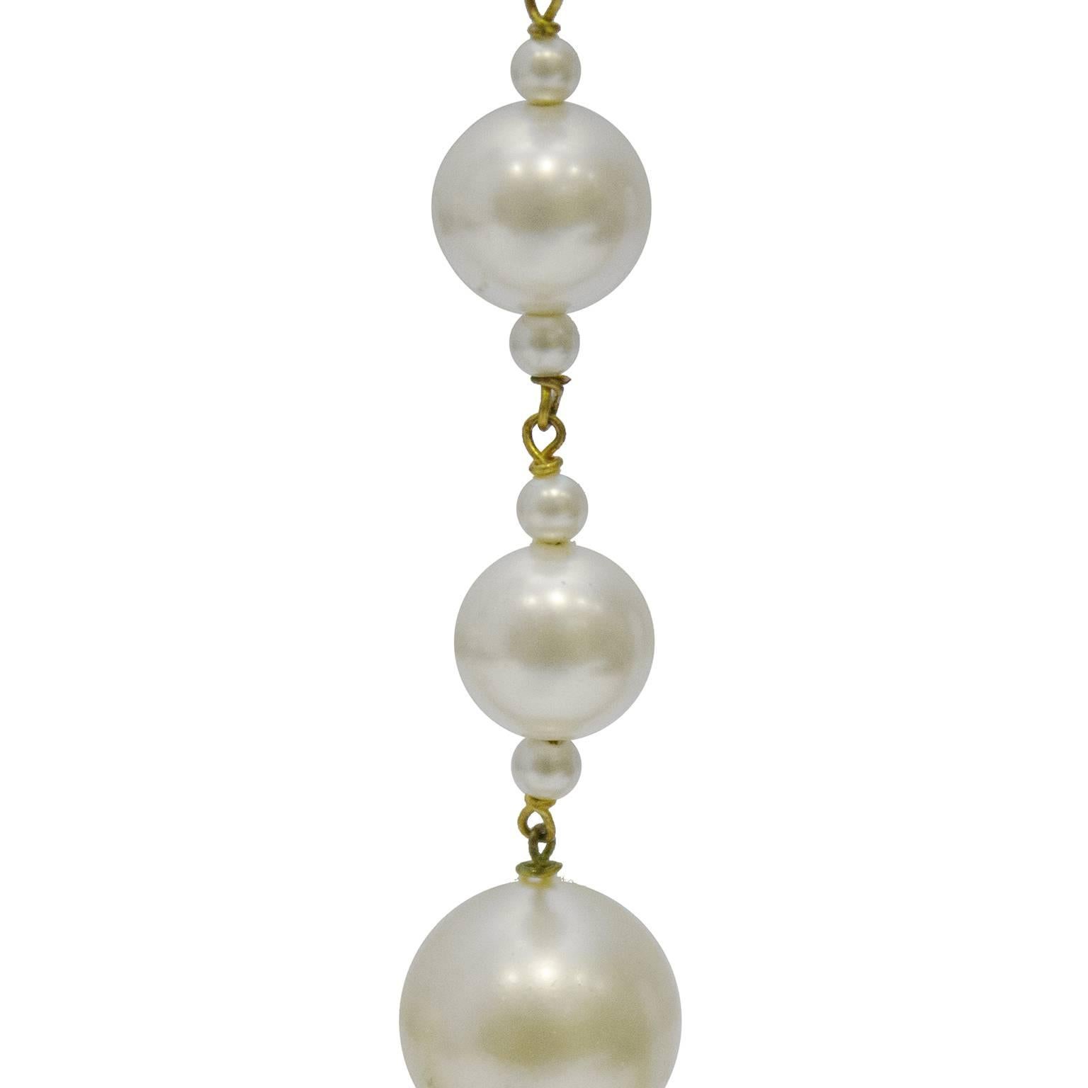 Chanel multi pearl drop earrings from the 1980's. The clip on style earrings are made of 5 large sized faux pearls with six tiny pearls and goldtone links. In excellent condition. 