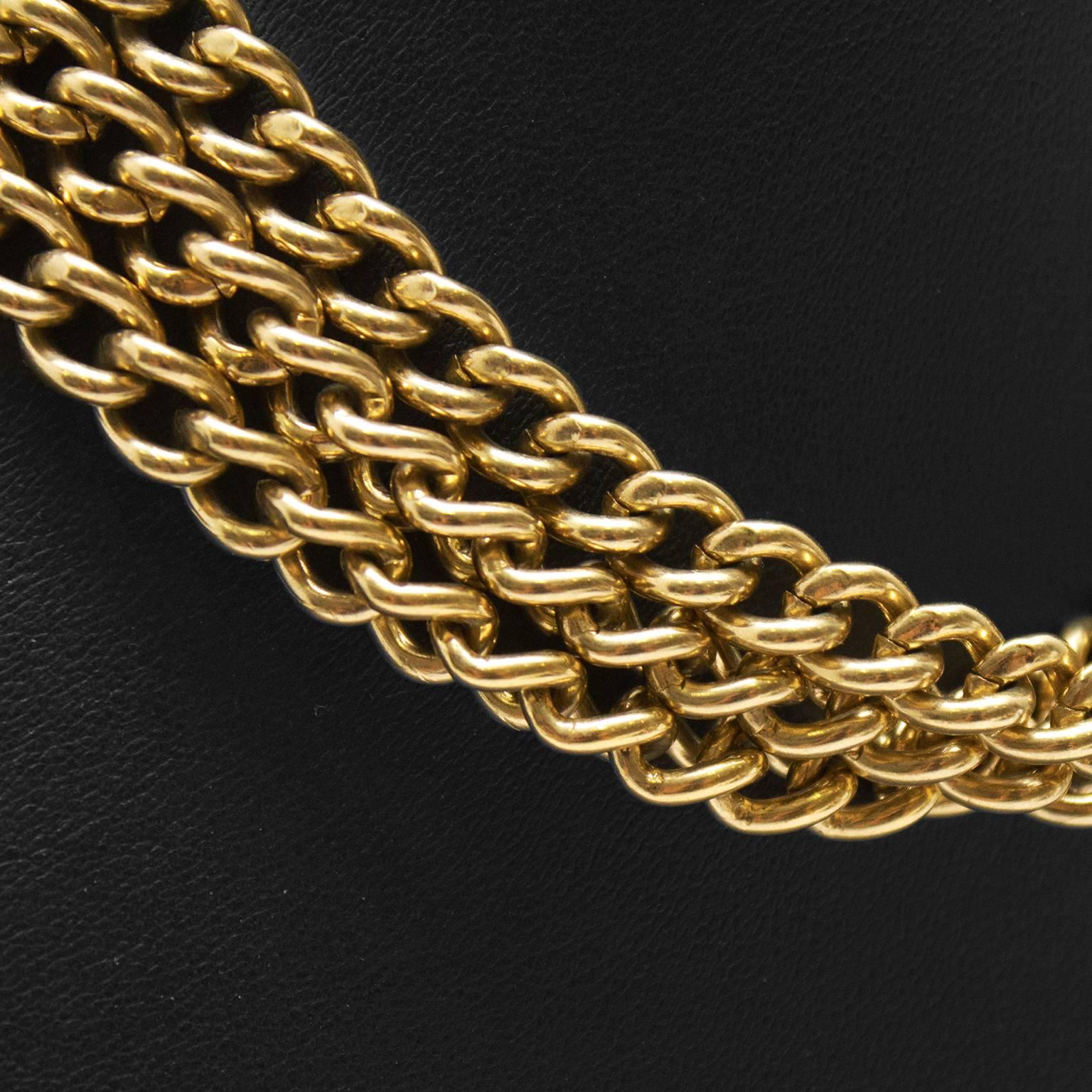 1980's goldotne triple strand chain choker by Givenchy. Fastens with a Givenchy Paris stamped clasp at the nape of the neck. Givenchy authenticity tag underneath clasp. In excellent condition. 