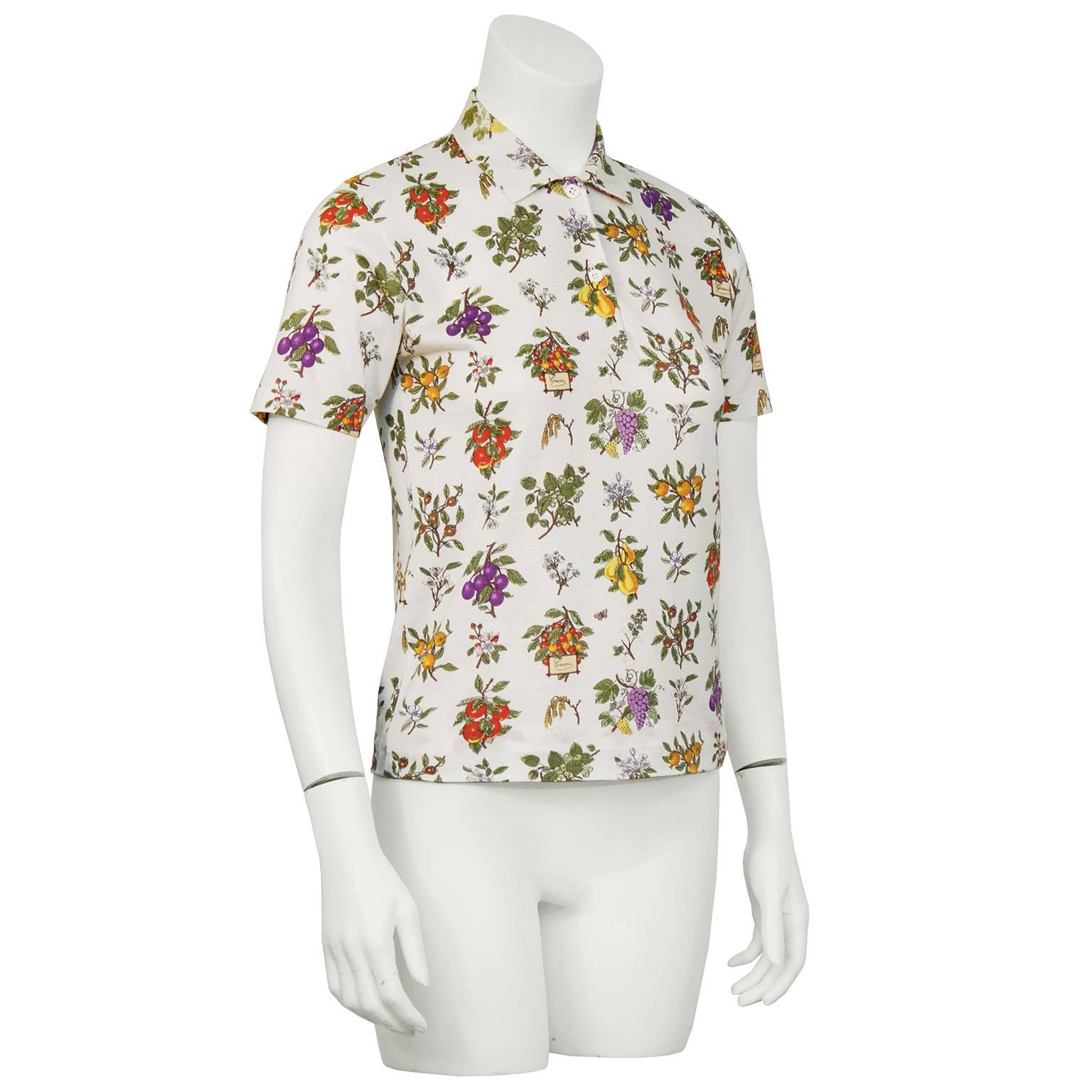 Early 1970's Gucci floral polo top in 100% fine cotton jersey. The look is classic, the fit is petite and the condition is very good vintage. There are some tiny areas of fading but hard to make out. Overall condition very good. Fits like a US size