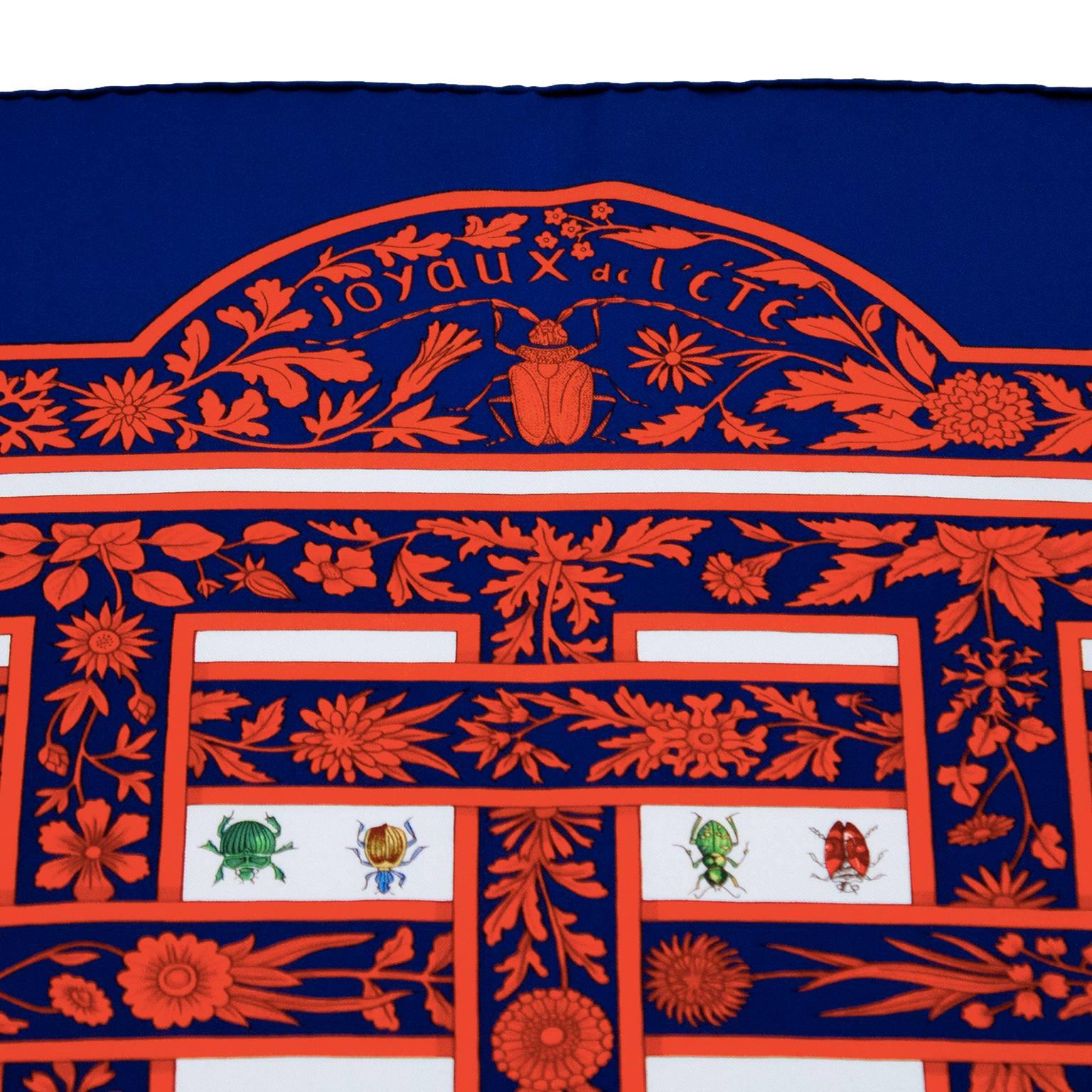 Mint condition 1995 Hermes Joyaux d'Ete navy and red silk scarf. Unused condition, vibrant coloration in red, and blue with multi colored butterflies and dragonflies. Designed by Antoine de Jacquelot. Measures 35.5