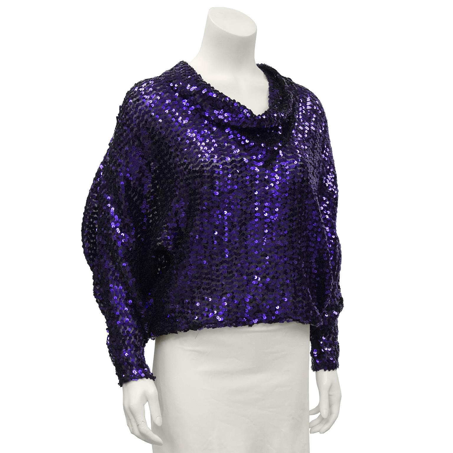 Versatile 1960's purple metallic sequin top with gathered stretchy hem and batwing style sleeves. Perfect to wear over jeans or to dress up a black pant for a special evening. Can be worn front or back, very little difference. In excellent