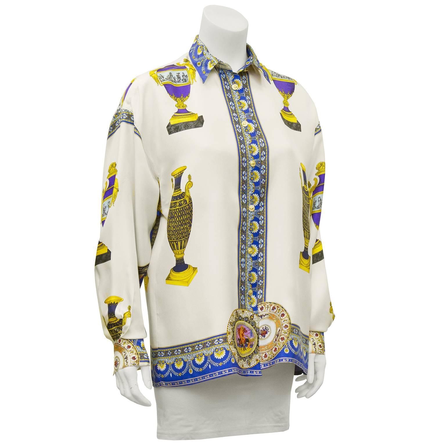 Stunning Versus by Gianni Versace silk ladies shirt with button front, collar and cuffs. A look that defined Versace in the early years, luxury fabrics printed with opulent designs in jewel tones and neo classical images. In excellent condition fits