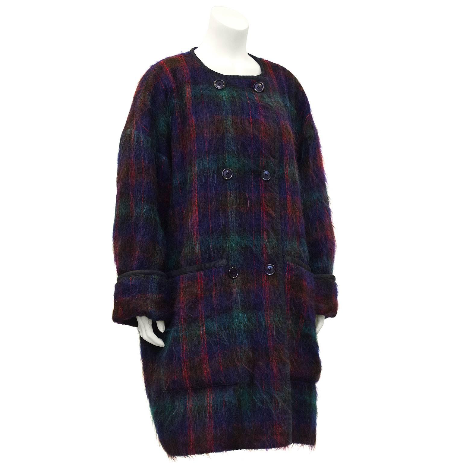 Lush 1980's Anne Klein mohair double breasted coat trimmed in dark navy suede. Subtle tones of purple, navy, burgundy and emerald green are woven together to create a muted plaid. In excellent condition fully lined in navy rayon acetate. Fits like a