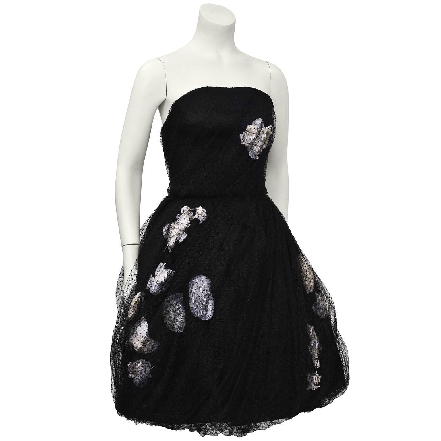 As seen on the beautiful actress Anne Hathaway. Simply exquisite 1960's black tulle pointe d'esprit strapless haute couture cocktail dress. Lush white gardenias are clustered in the bodice and full skirt to add a unique touch. Small fit, fully boned