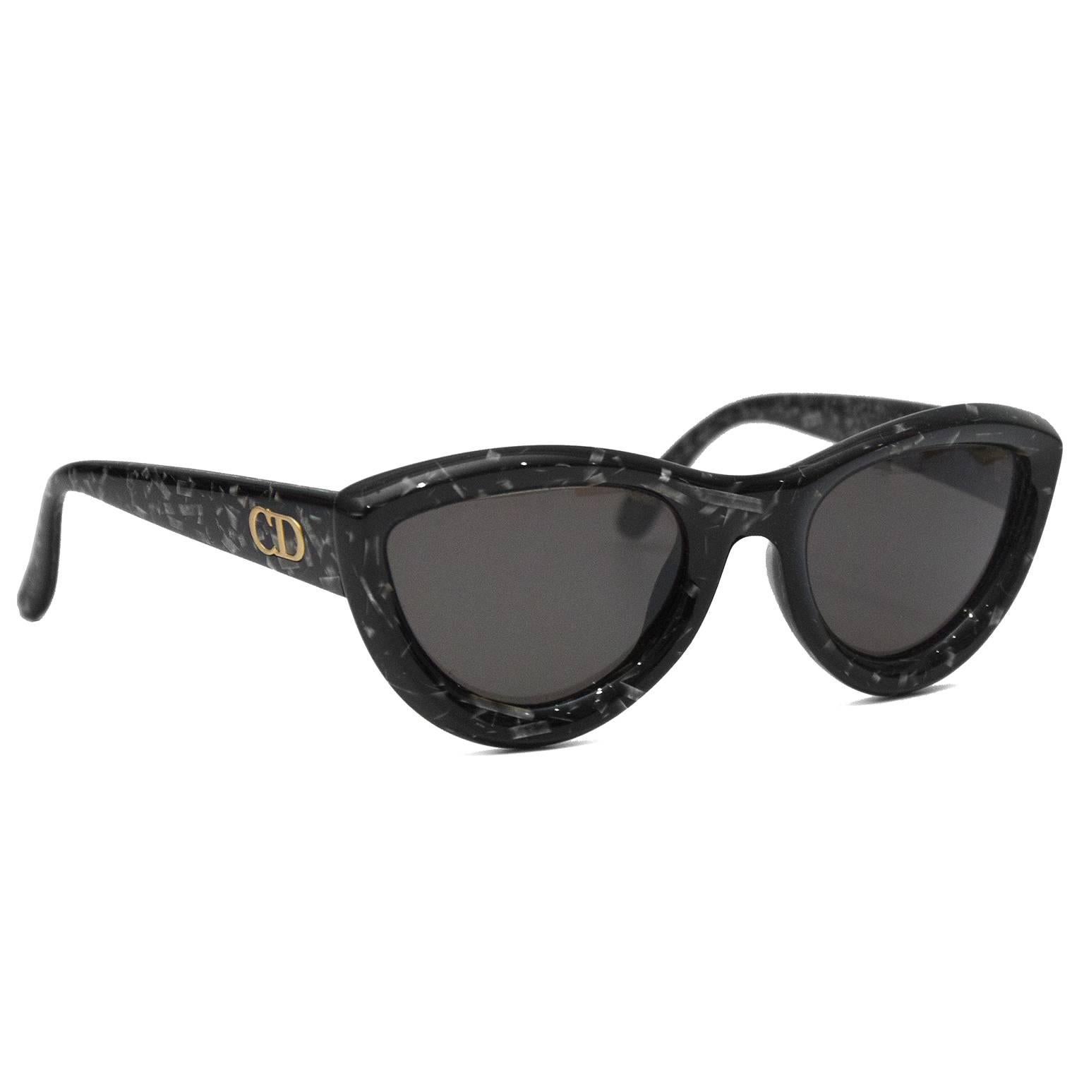 Chunky black acetate marble effect Dior sunglasses. Dating from the 1990's in their original case, these cats eye shaped glasses are in excellent condition with dark grey black lenses and gold CD logo on the arm. 