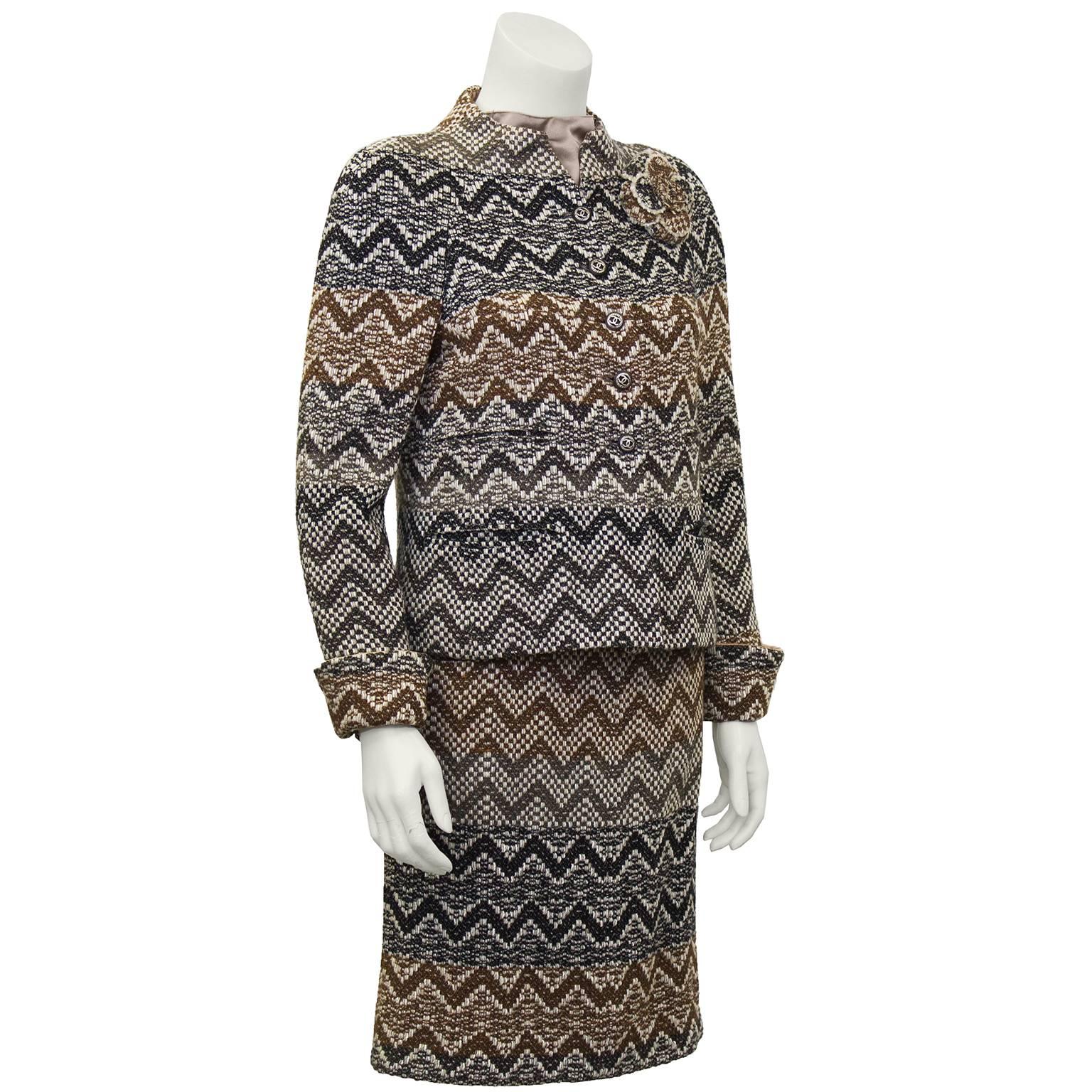 Chanel F/W 05 gray taupe and cream chevron pattern boucle skirt and jacket with matching taupe satin sleeveless shell. Detachable matching signature 'Camilla' flower pin at bust. Excellent Condition. Fits like US size 4.

Jacket: Sleeve 16