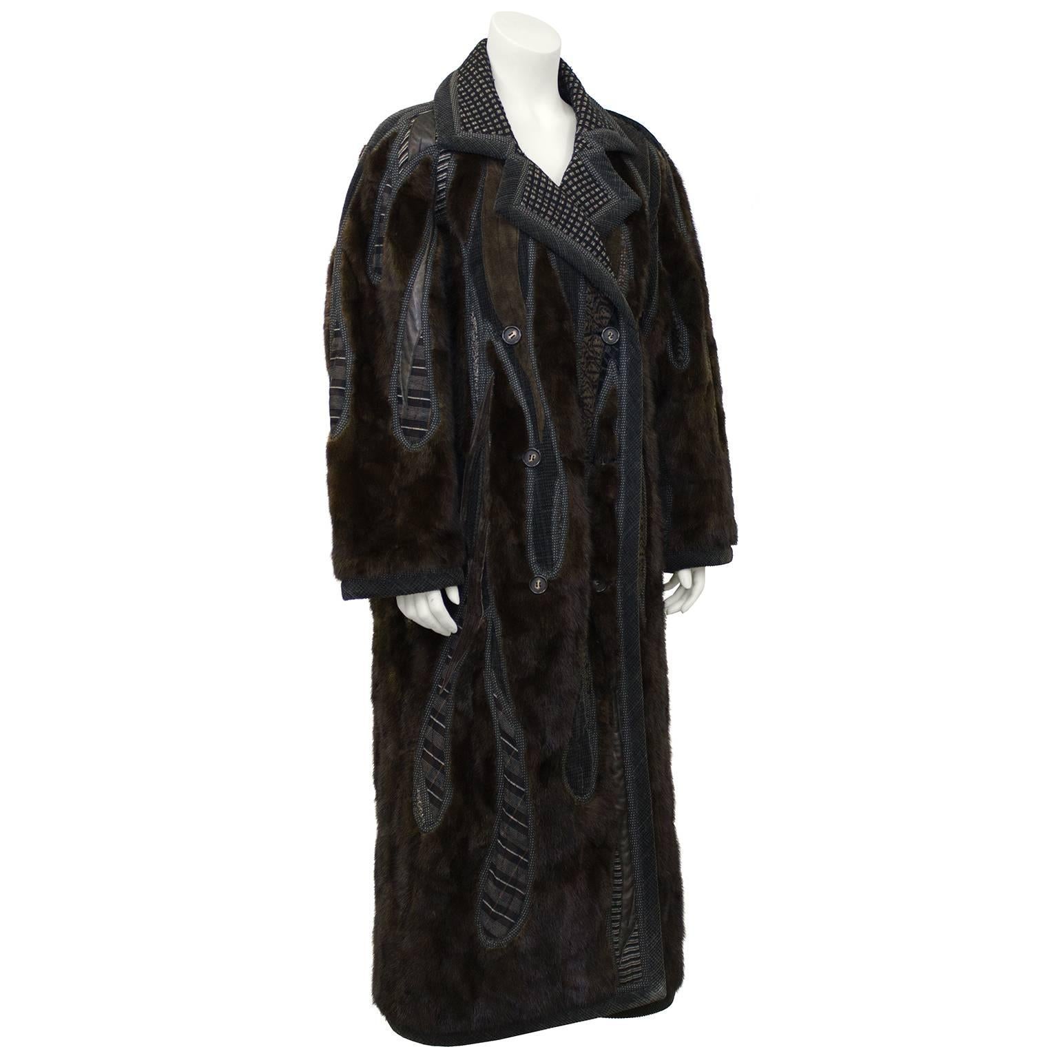 1990's unique wearable art by Koos Van Den Akker Couture. Winter weight, double breasted, drop shoulder Chesterfield shape with hand designed patchwork inserts of deep brown mink, black and cream wool checked fabric, brown leather and suede along
