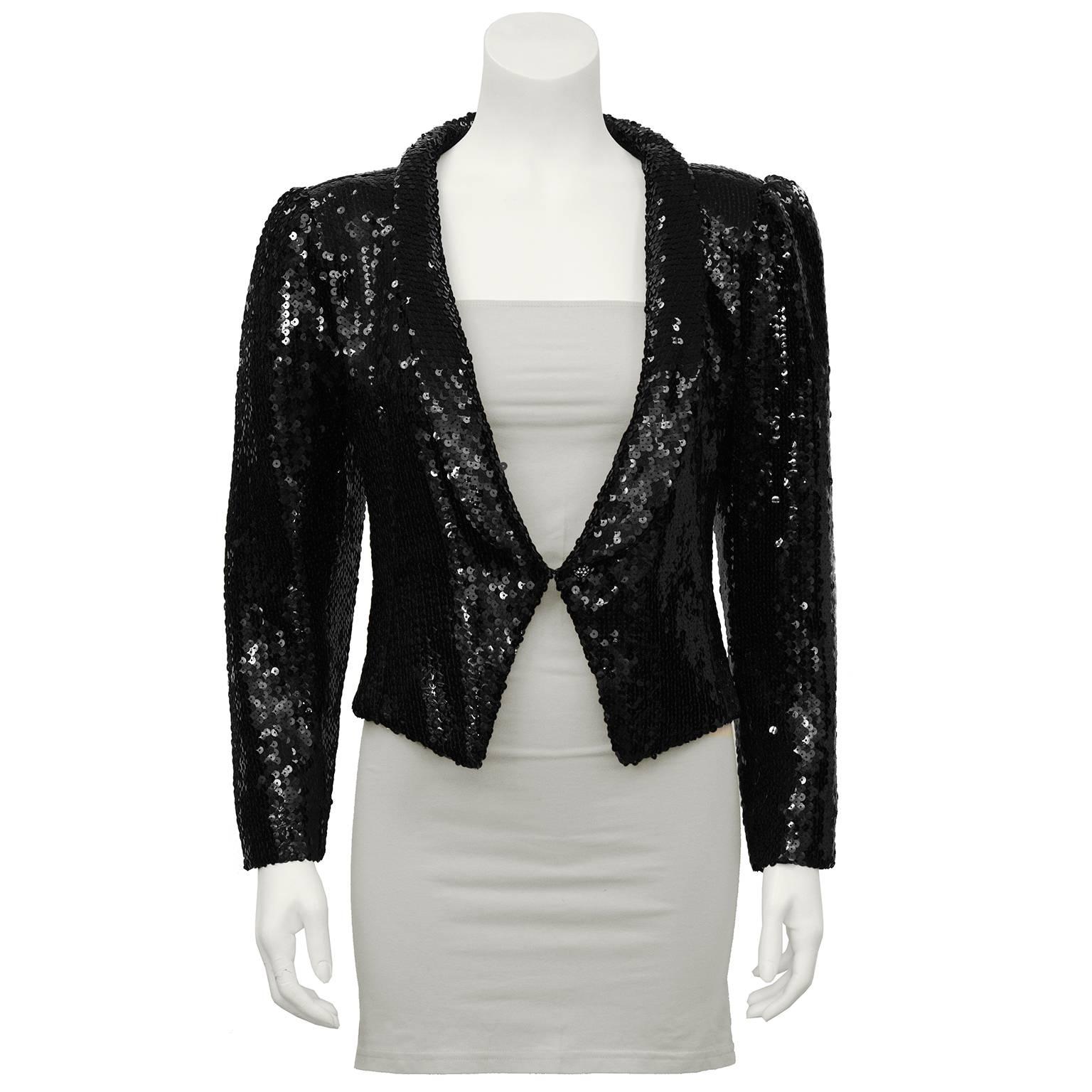 1980's Ungaro fully sequined black cropped jacket. Perfect timeless piece to throw on over a LBD or your favorite jeans and white T-shirt. Slight gather to the shoulder adds a touch of femininity with a narrow shawl collar and a single center hook