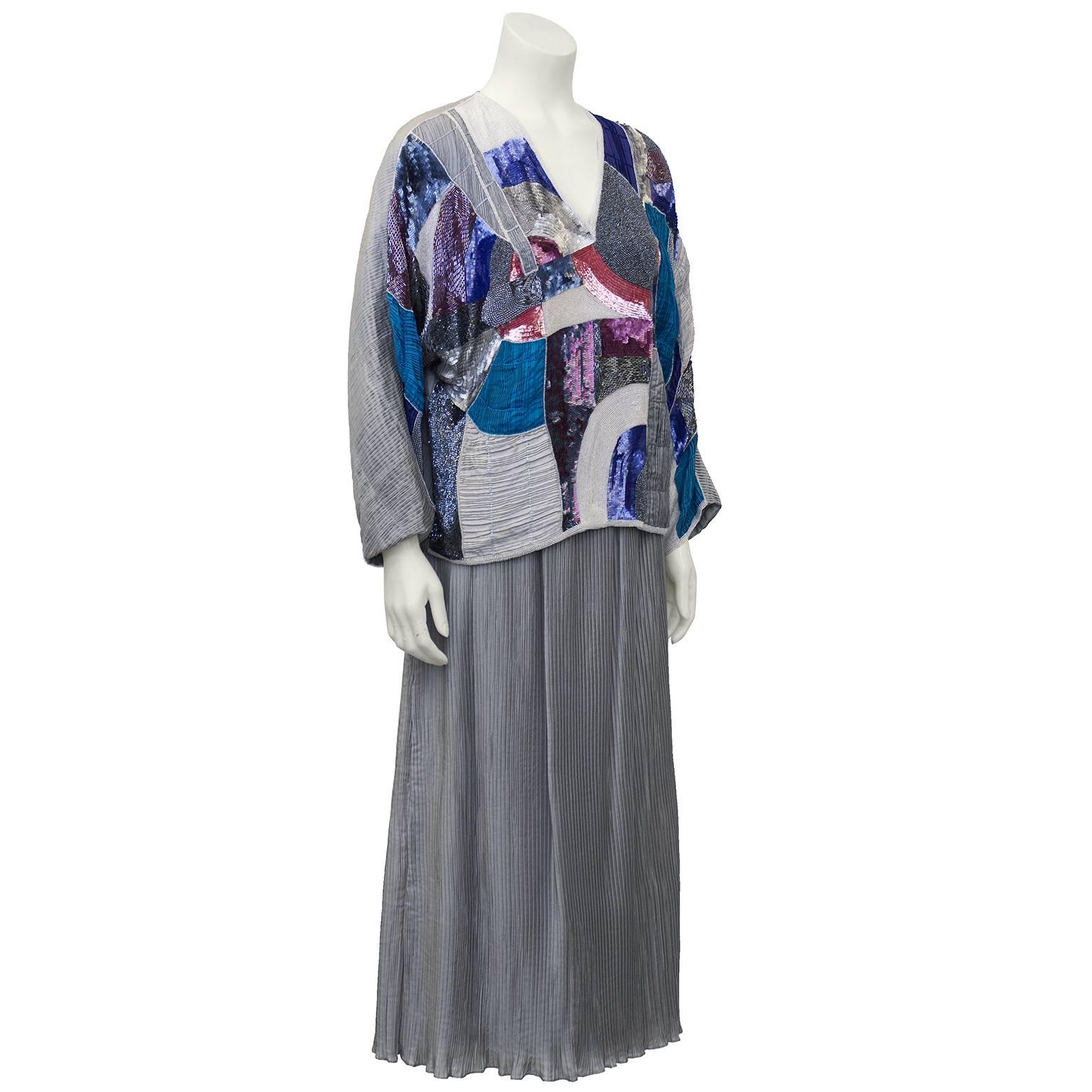 1980's Italian evening set with multi colored sequin and beaded top and micro pleated silver mid calf skirt. Inspired by Mary McFadden from her Fortuny era pleated gown. The ideal way to dress for evening, the beaded top can be worn over a pair of