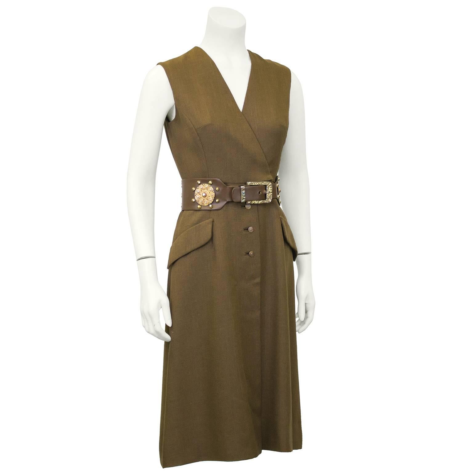 Great 1960s Shannon Rodgers piece. Brown wrap style, sleeveless, day dress with detailed gold buttons down the centre. Matching brown waist belt with large gold embellishment. Some age and wear showing on the belt, interior mostly. Dress in great