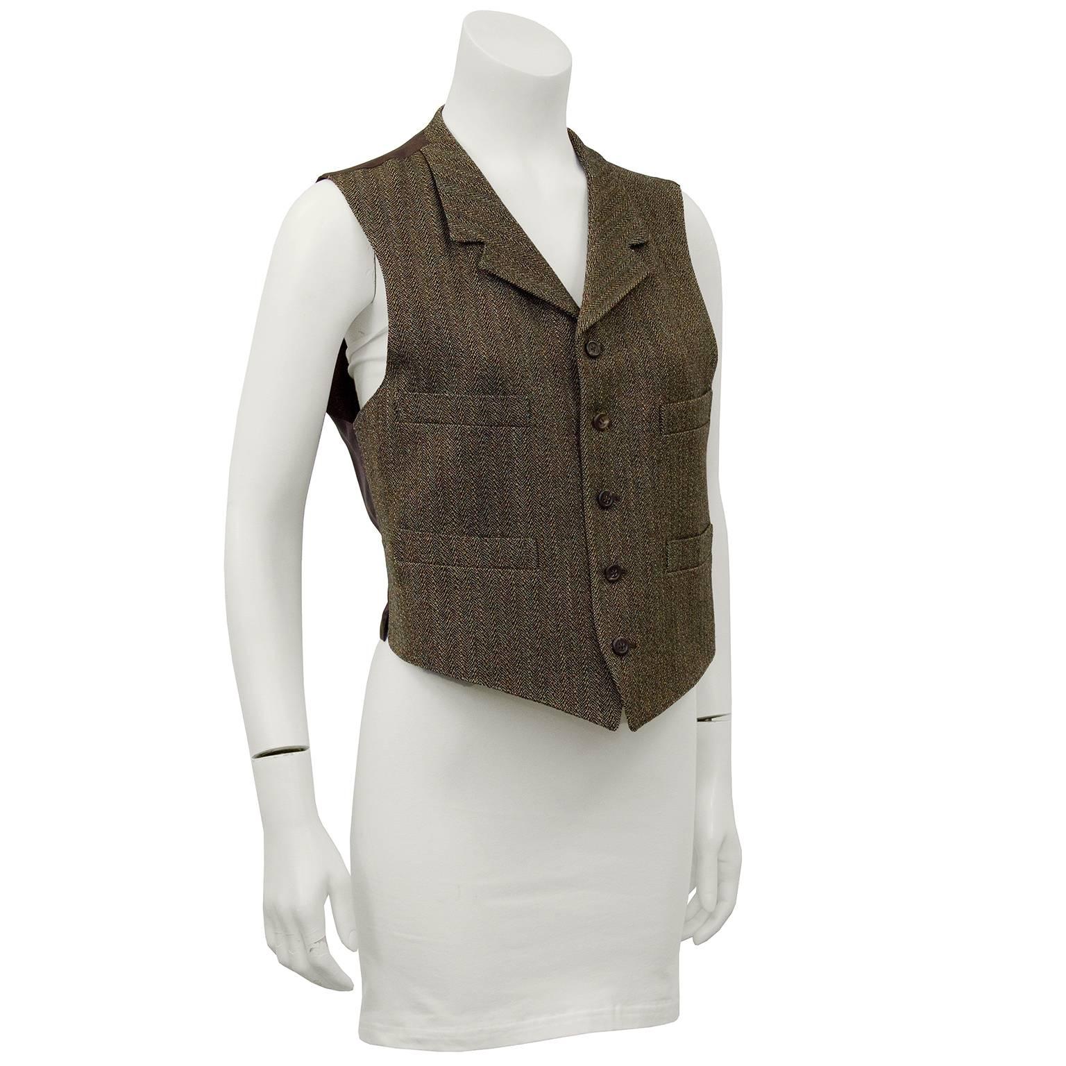 1980's Purple label by Ralph Lauren brown wool herringbone vest with brown silk back. Four slit pockets on front and adjustable belt at back. Iconic mens  suiting details that symbolized Ralph Lauren's unisex approach to classic dressing. Excellent