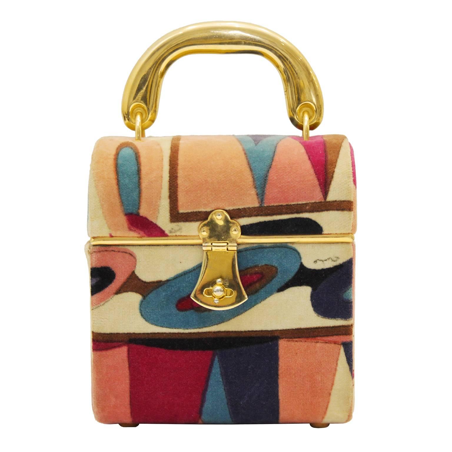 Beautiful petite 1970's Emilio Pucci velvet pink and purple printed hard case box style hand bag with a gold top handle and kiss lock closure. Lined in dark pink leather with one interior pocket. The exterior is in excellent vintage condition with