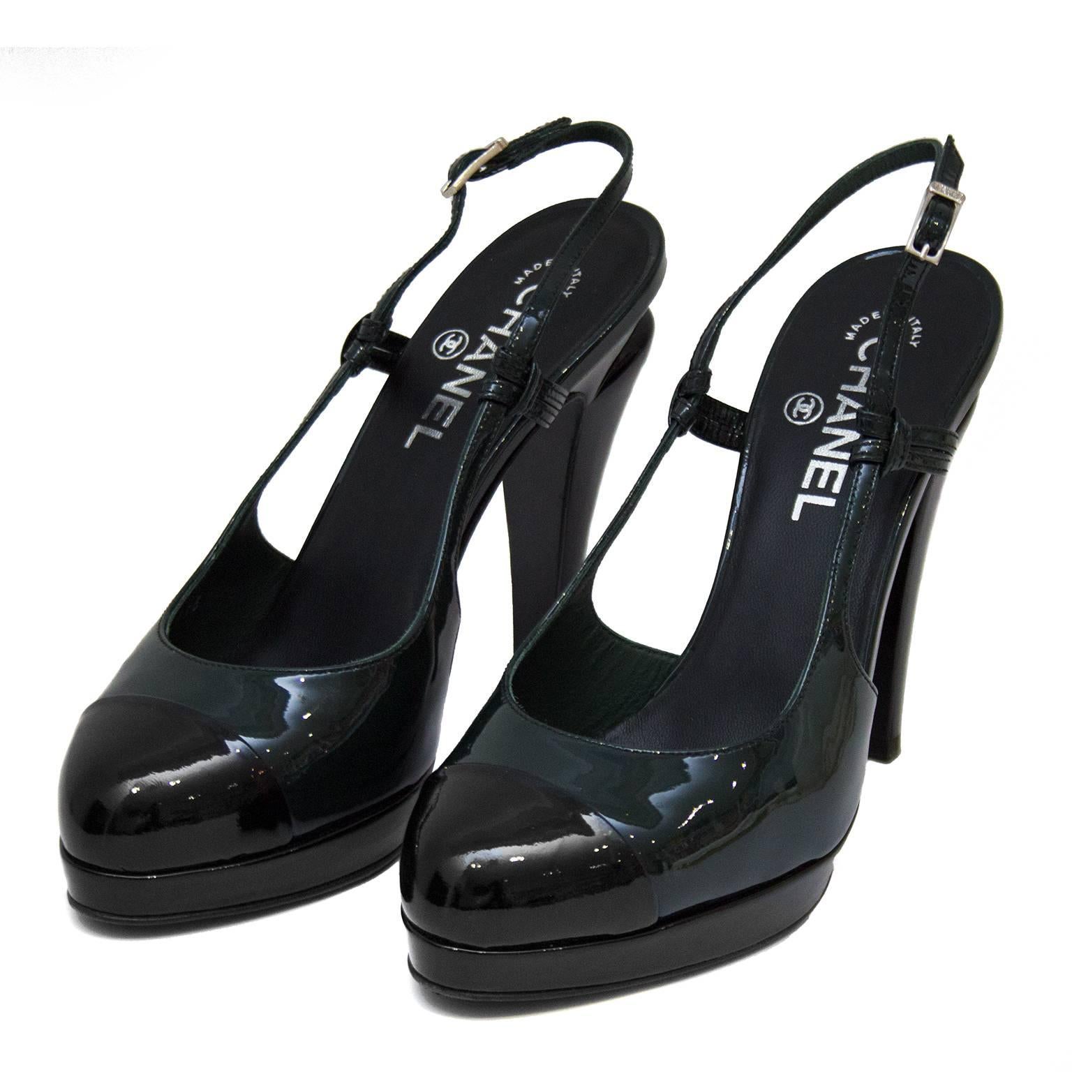 2000's Chanel patent leather high heels. Two-toned dark green with black cap toe, platform and heel. Sling back with silver buckle. 5" heel with small cut out. Black leather insole with silver brand stamping. Very light wear to soles. Size FR