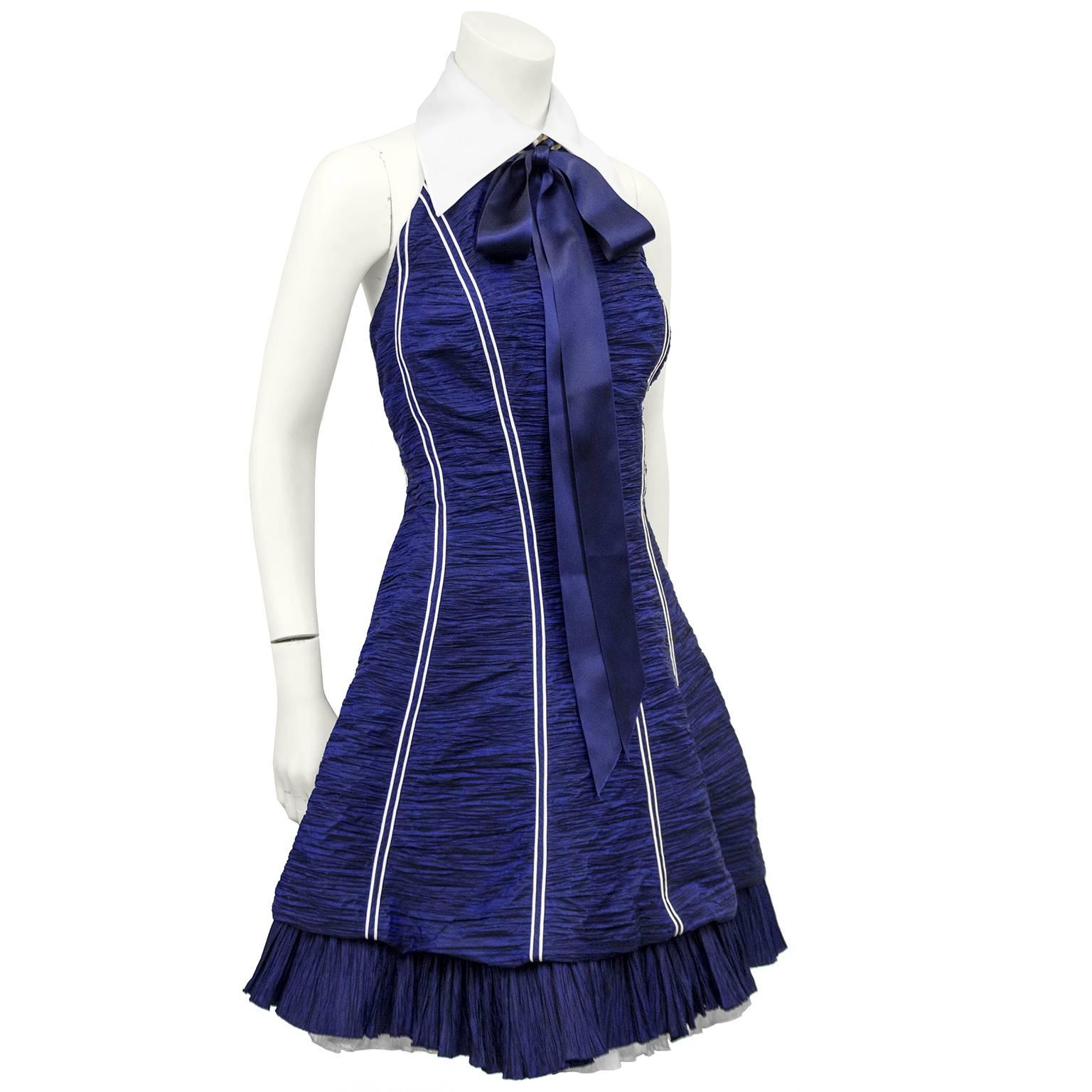 Adorable 1980s Jacques Fath cocktail dress. Horizontal micro pleated navy blue and black with thin white vertical stripes. Vertical micro pleated frill at hem with white underskirt. White silk gauze oversized collar at halter neckline with thick