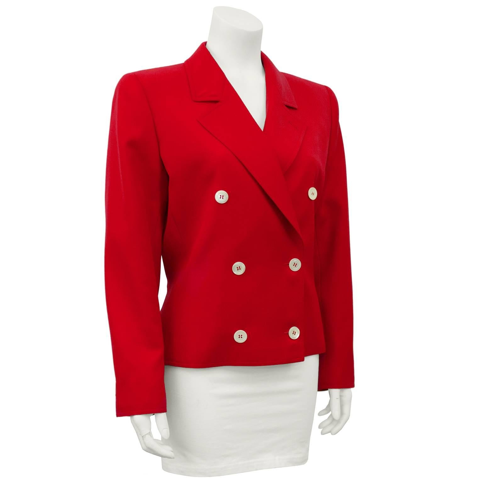 Chic double breasted light weight wool red jacket from the Miss V line by Valentino from the 1980s. The bright red fabric is accented with crisp white buttons down the front and a notched lapel. Seams down the front give this jacket a great shape